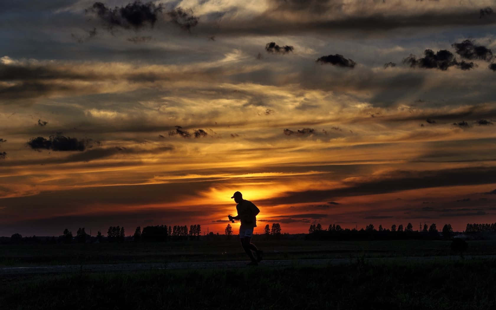 Athlete Silhouette Running During Sunset Wallpaper