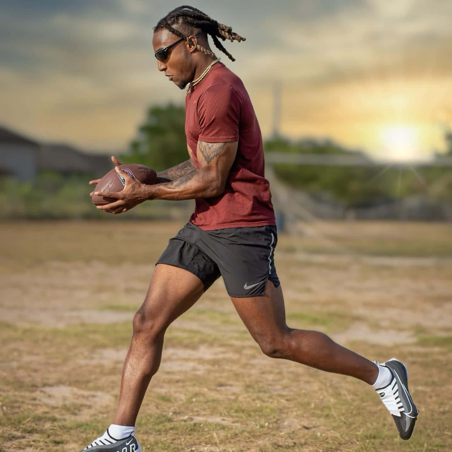 Athlete Running With Football Outdoors Wallpaper