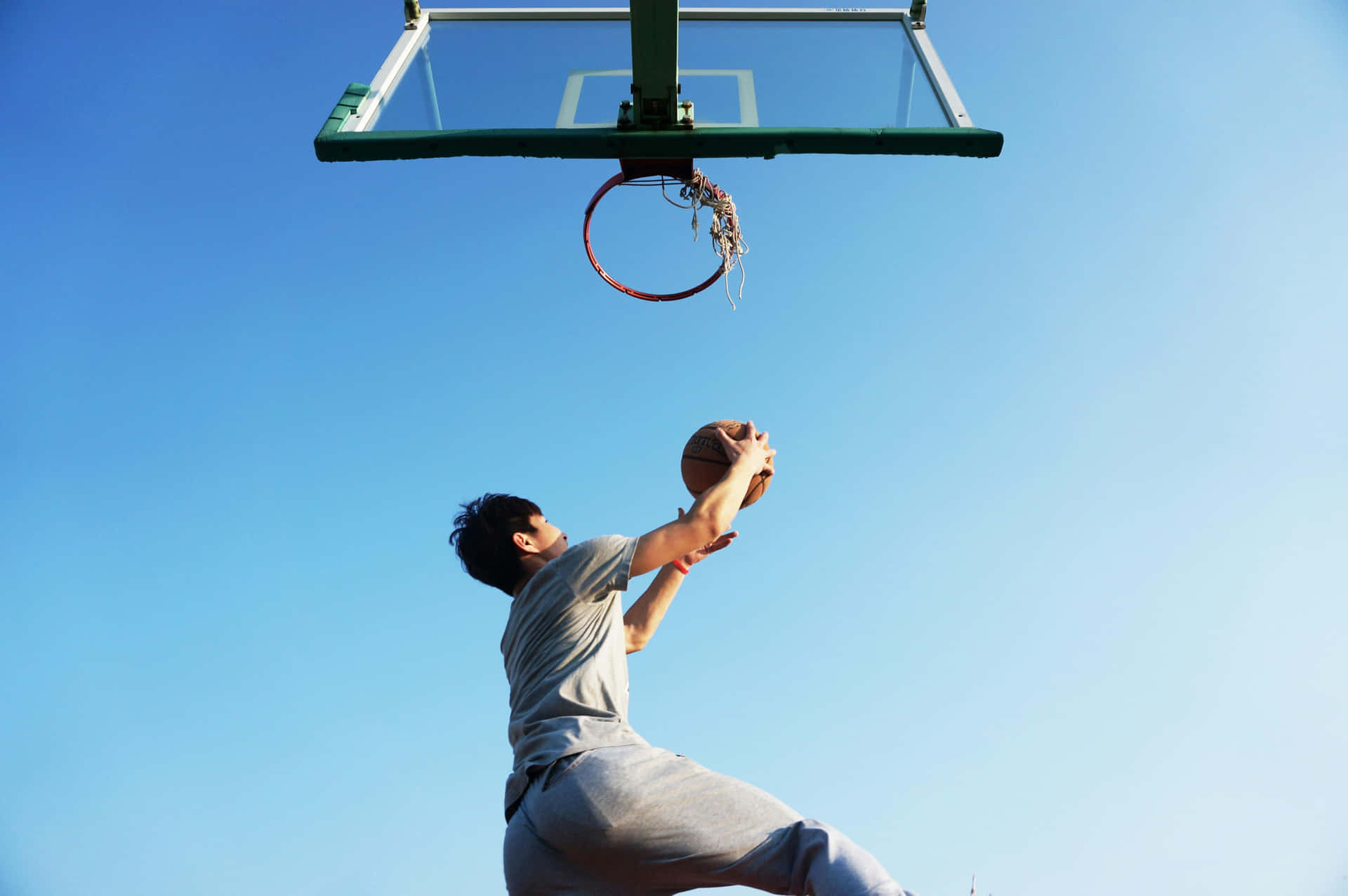 Athletic Basketball Player Jumping Shot Wallpaper