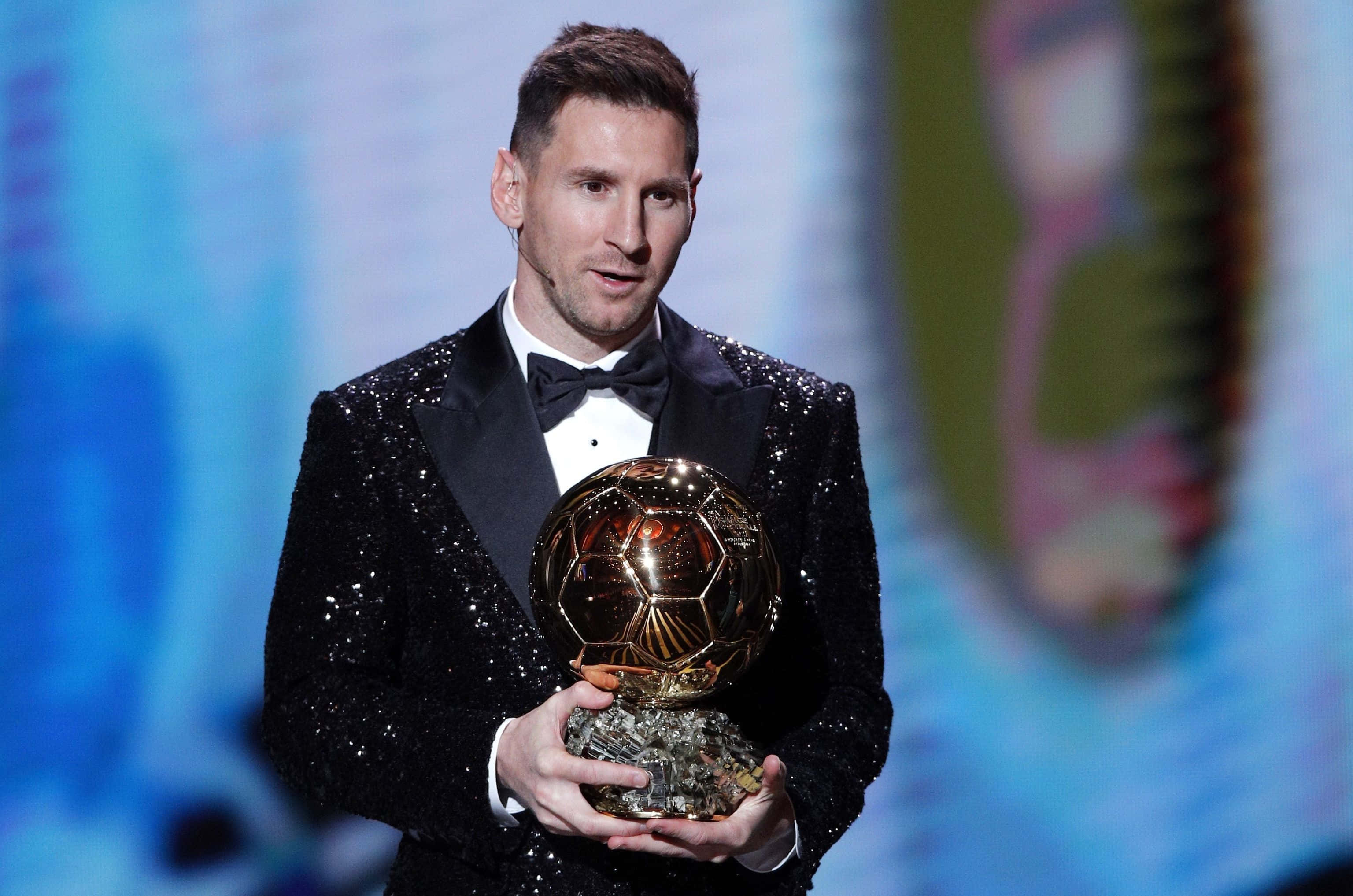 Athletic Excellence – Lionel Messi With The Ballon D'or Wallpaper