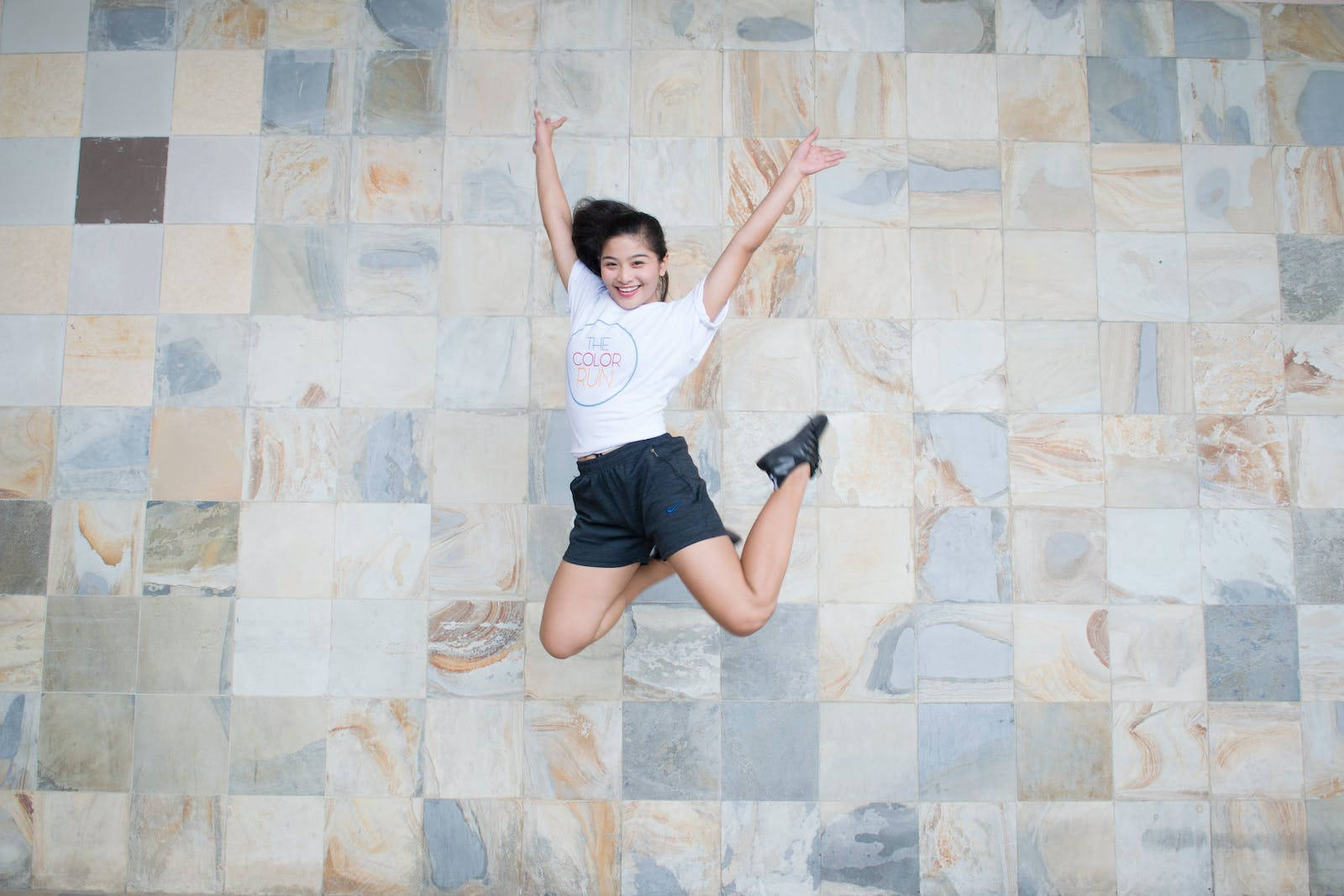 Athletic Jumping Against Tile Wallpaper