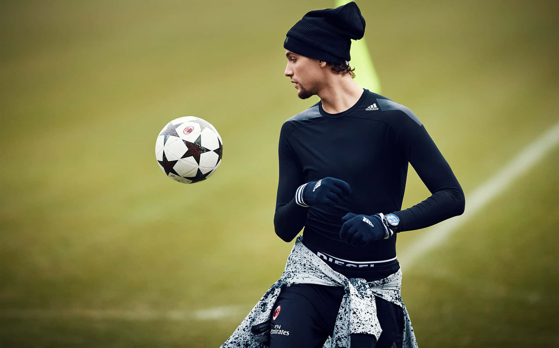 Athletic Young Man Performing A Freestyle Soccer Trick Wallpaper