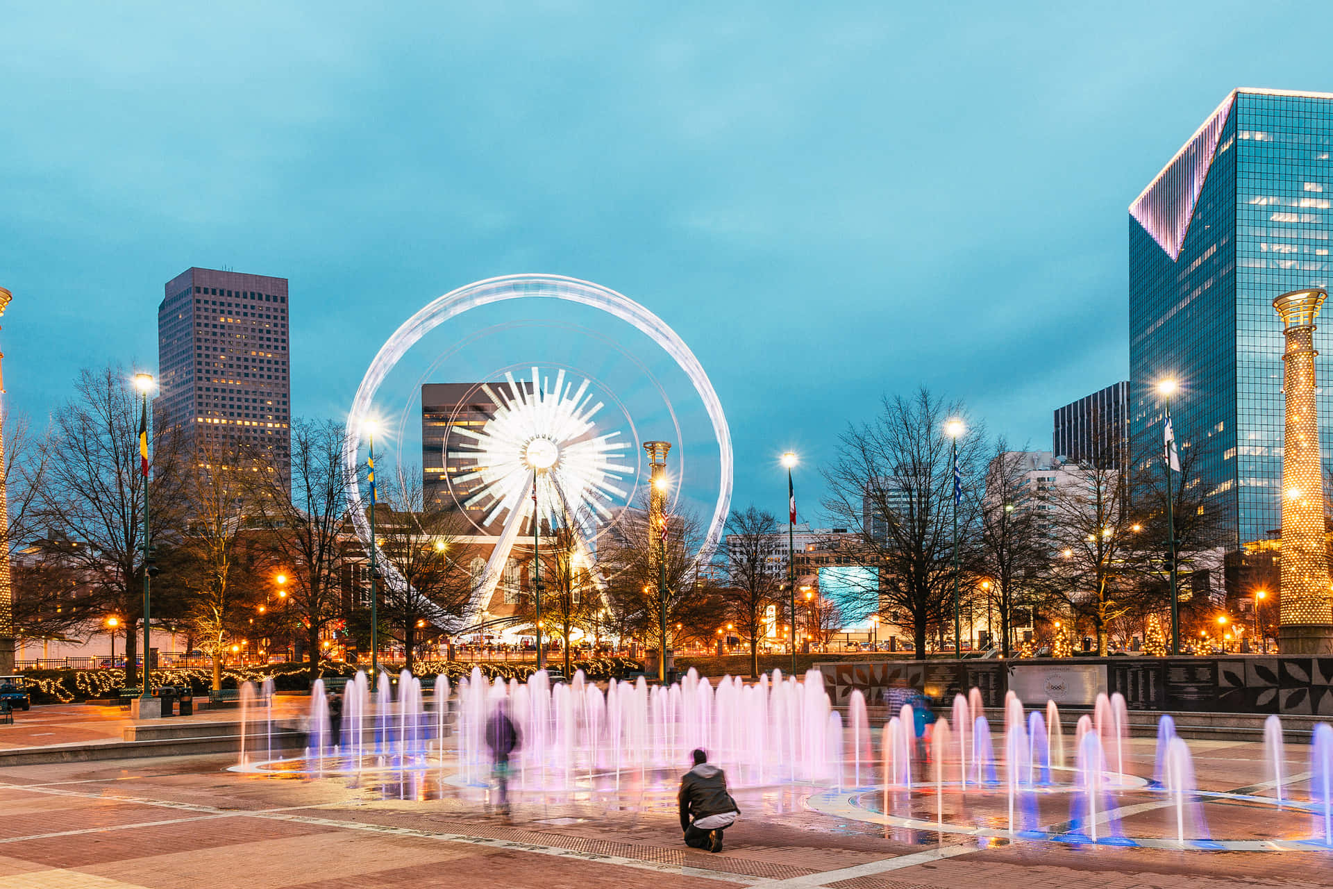A City With A Fountain And A Ferris Wheel