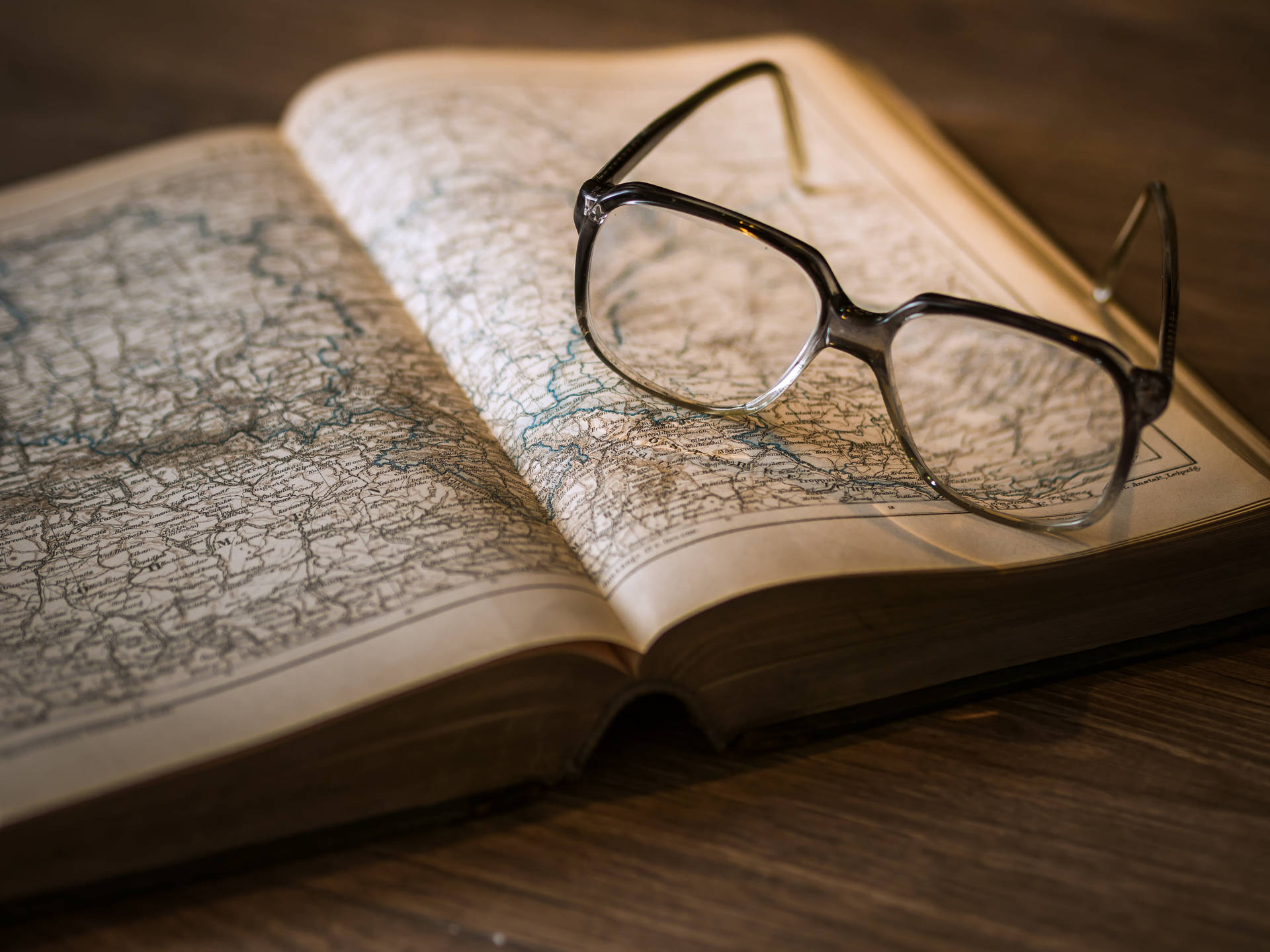 Atlas Reference Book With Eyeglasses Wallpaper