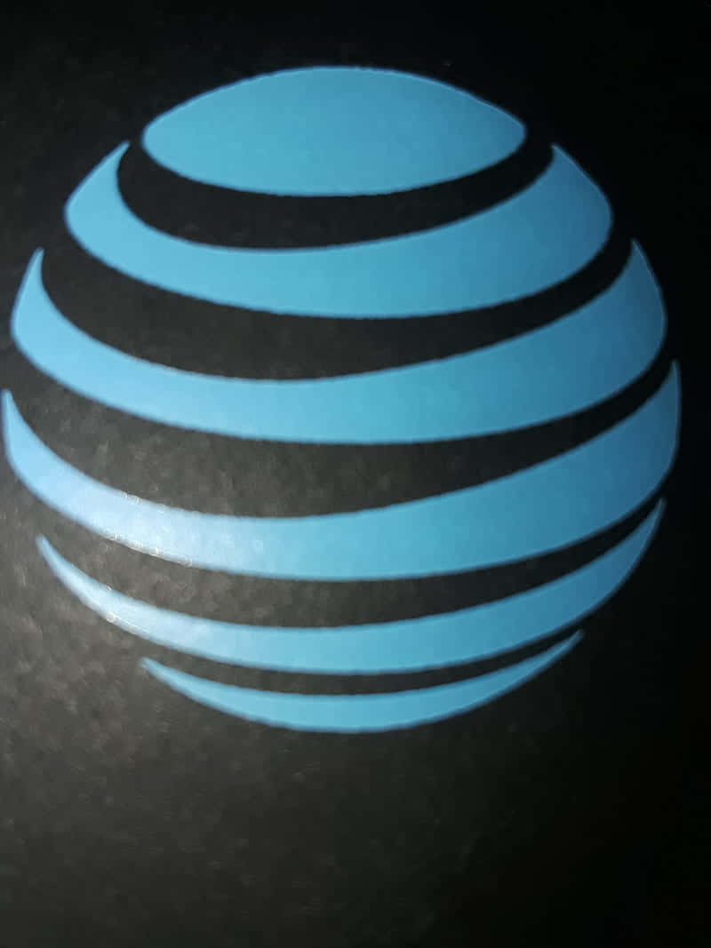 A Blue At&t Logo Is Shown On A Black Background Wallpaper