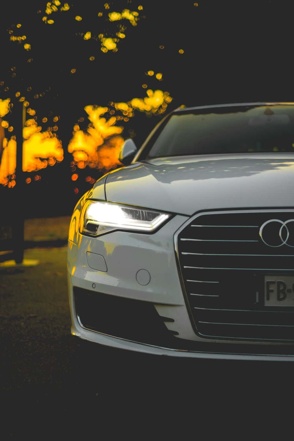 Sleek and modern Audi A4 parked by the lake Wallpaper