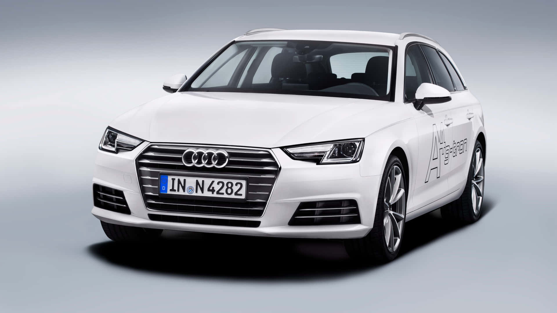 Sleek Audi A4 showcasing its elegant design and sophistication on the city streets. Wallpaper