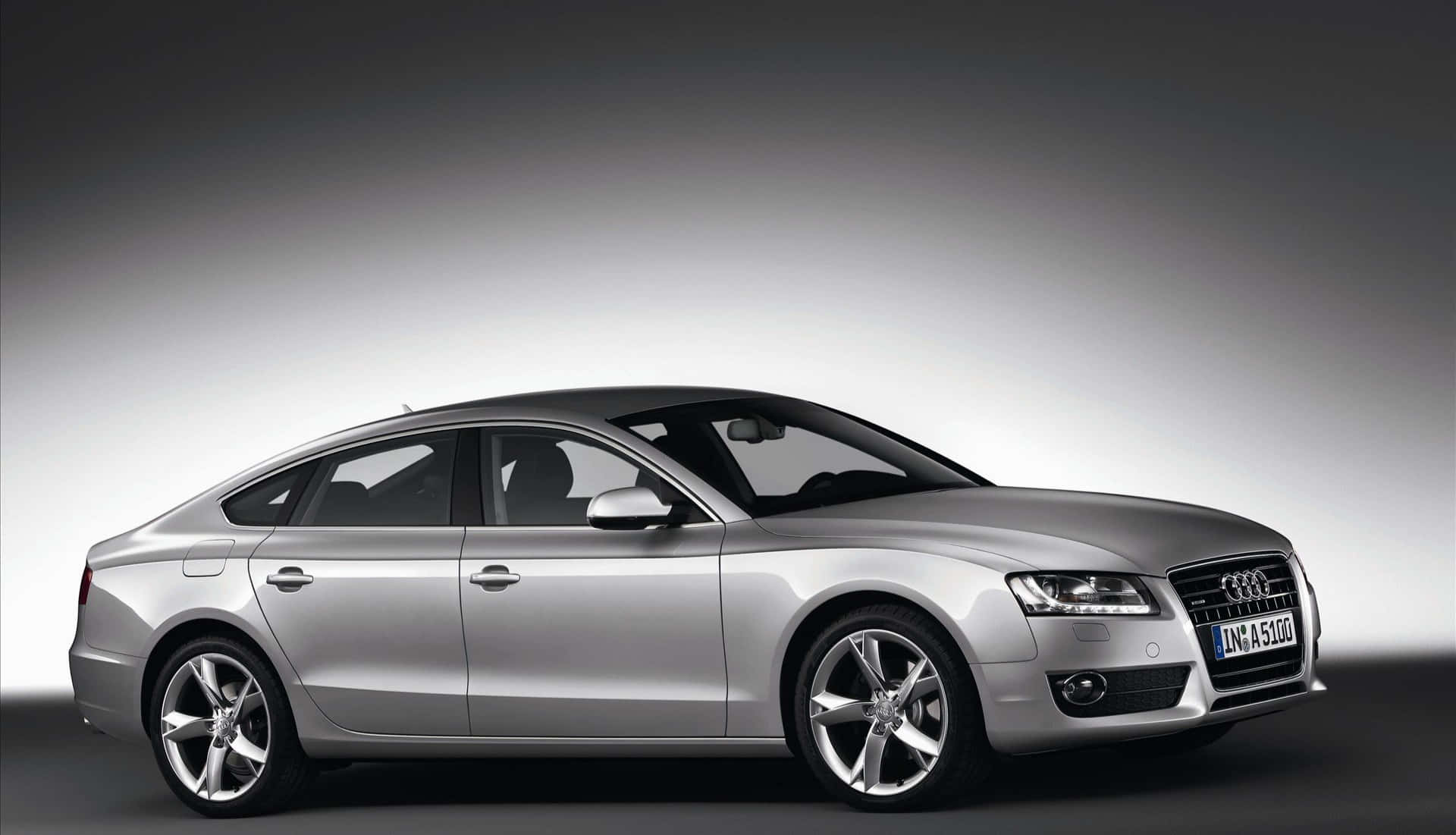 Sleek and stylish Audi A5 on the road Wallpaper
