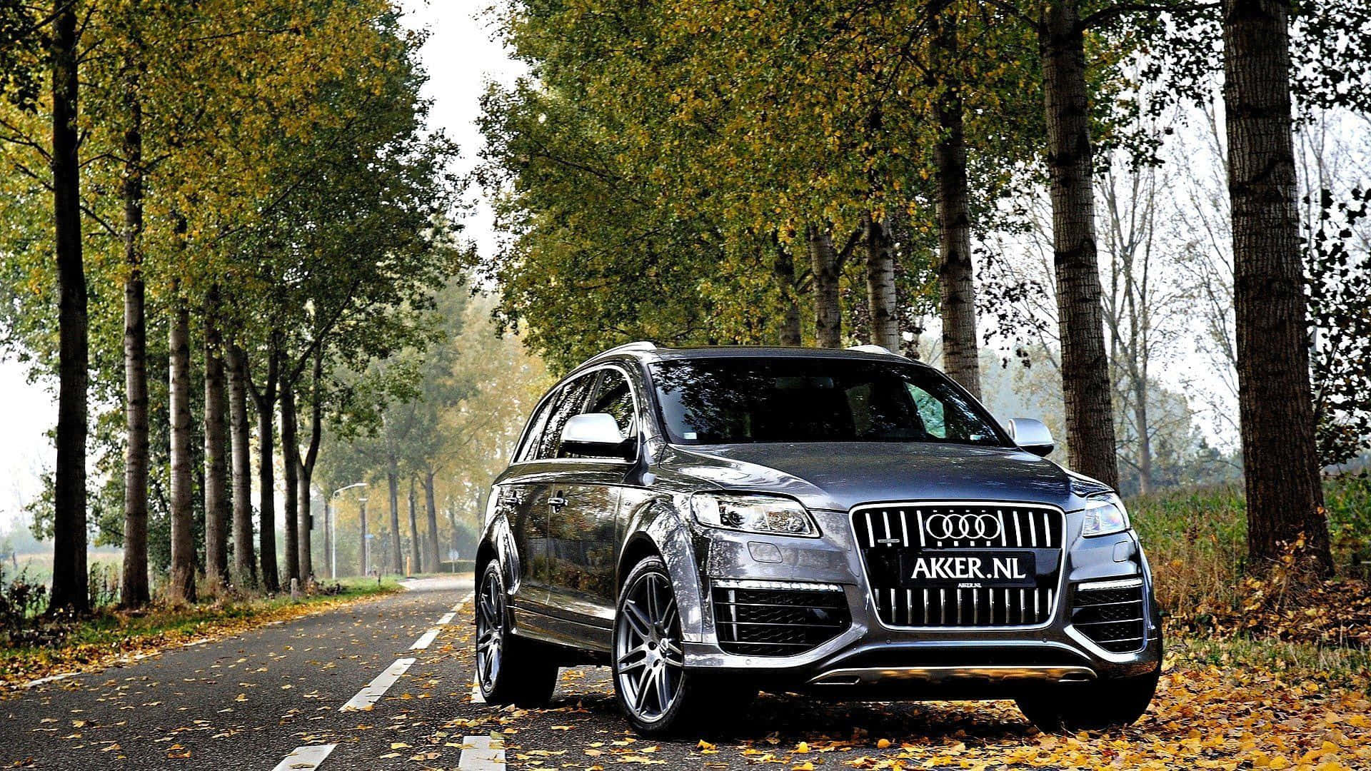 Caption: Stunning Audi Q7 in a Picturesque Landscape Wallpaper