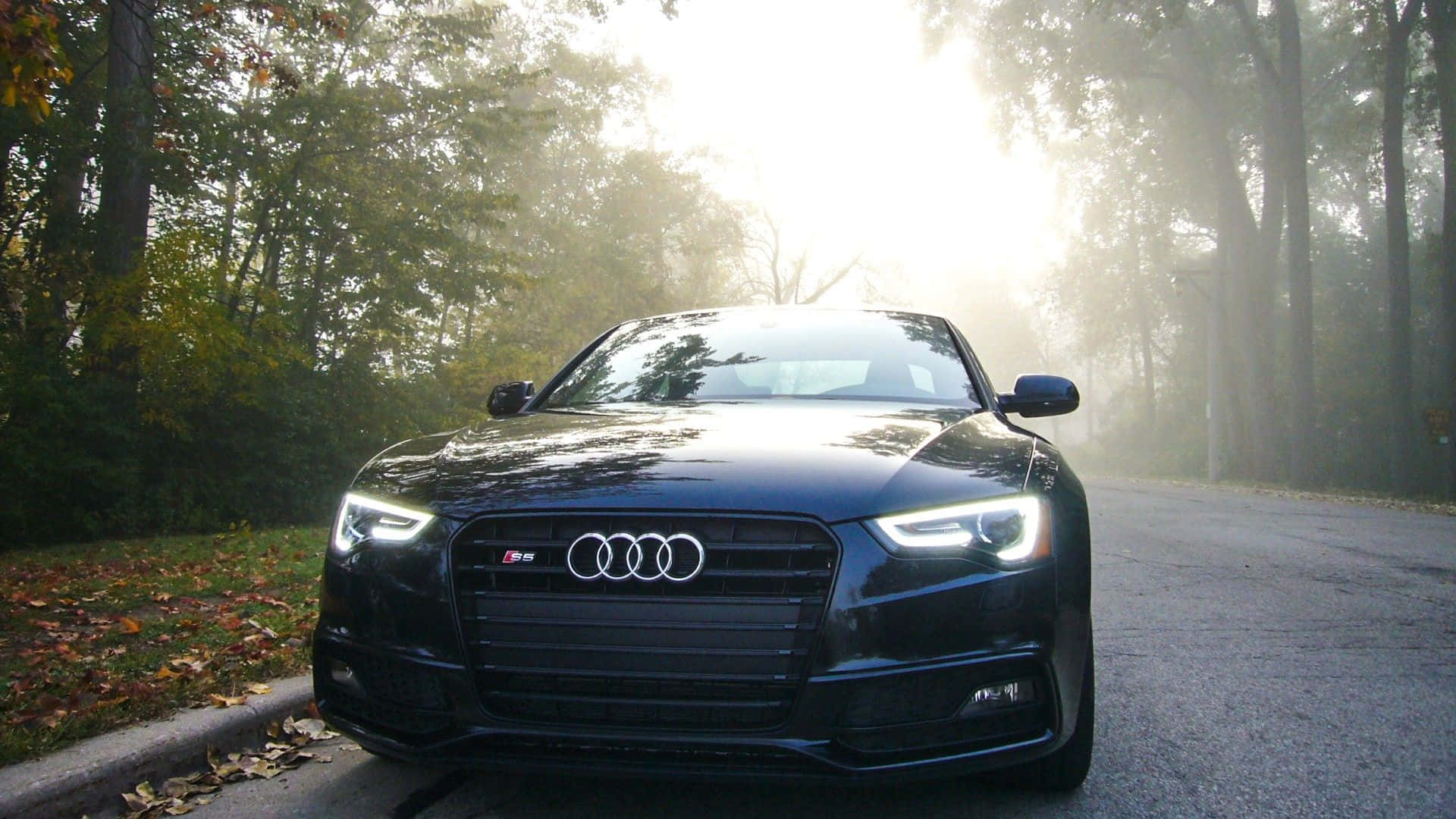 Stunning Audi S6 in motion on a scenic road Wallpaper