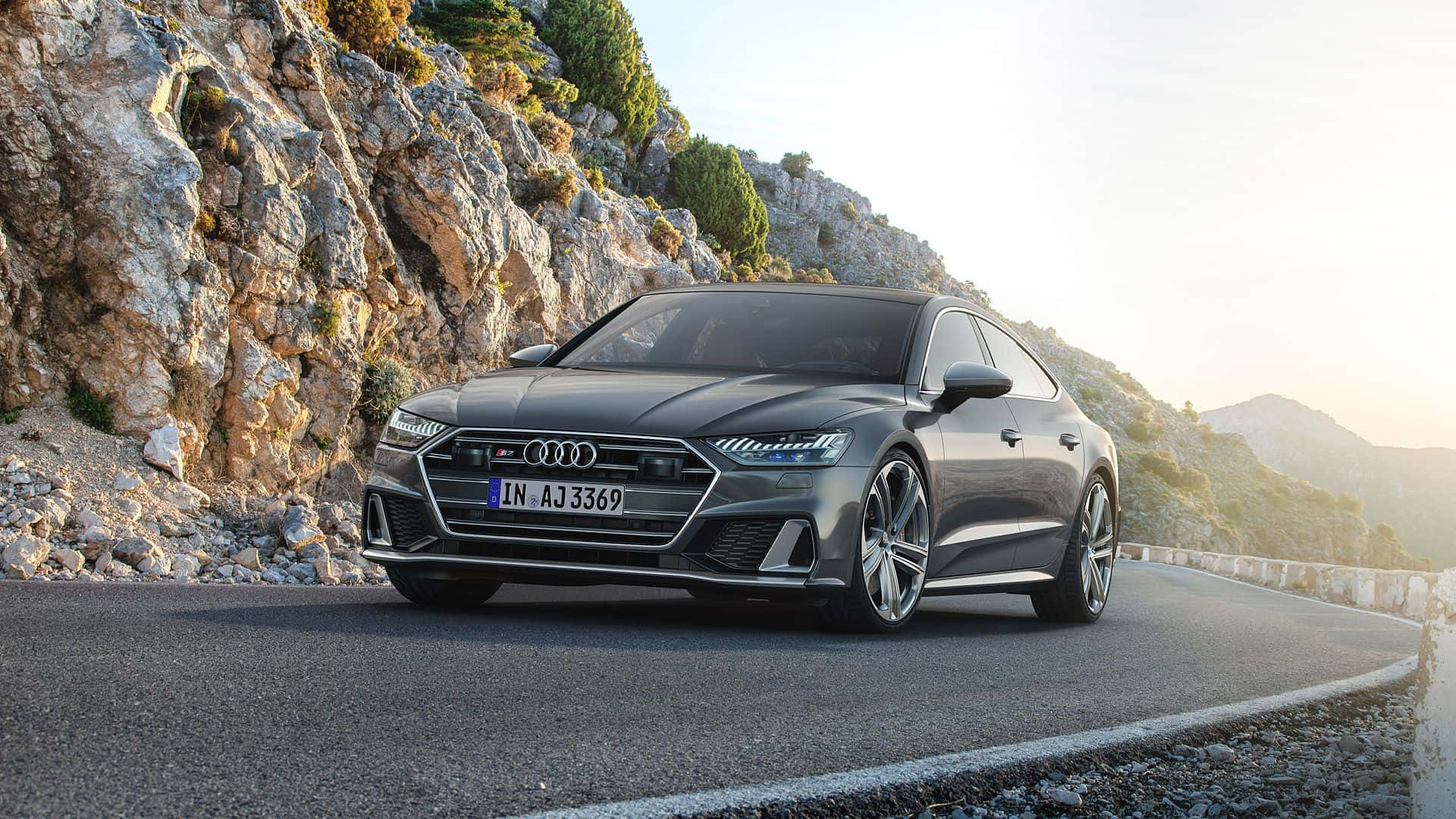 The luxurious Audi S7 speeding through a picturesque landscape Wallpaper