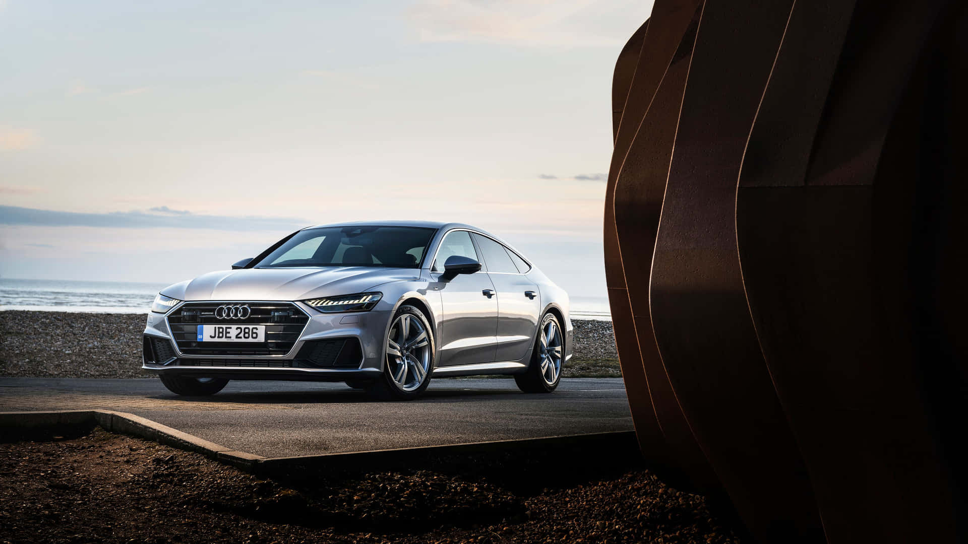 Stunning Audi S7 in motion on a picturesque road Wallpaper