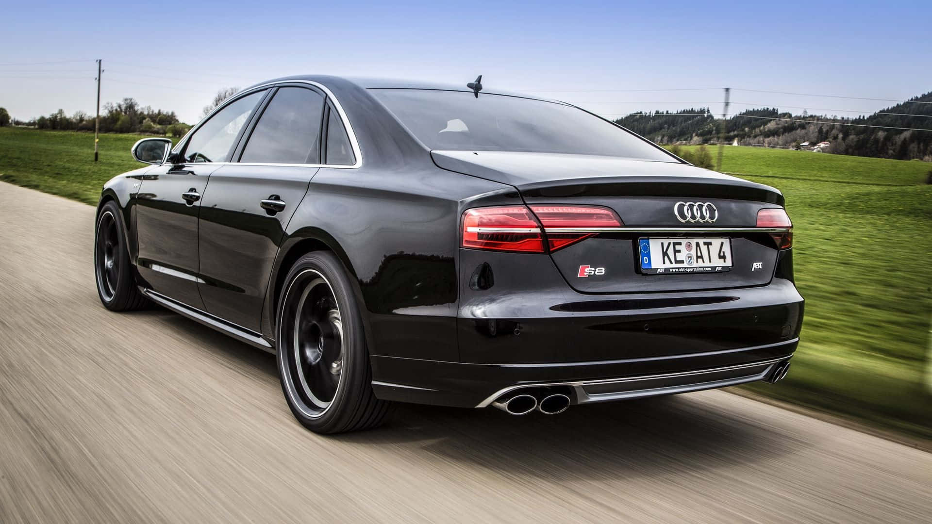 Sleek Audi S8 cruising on a highway Wallpaper