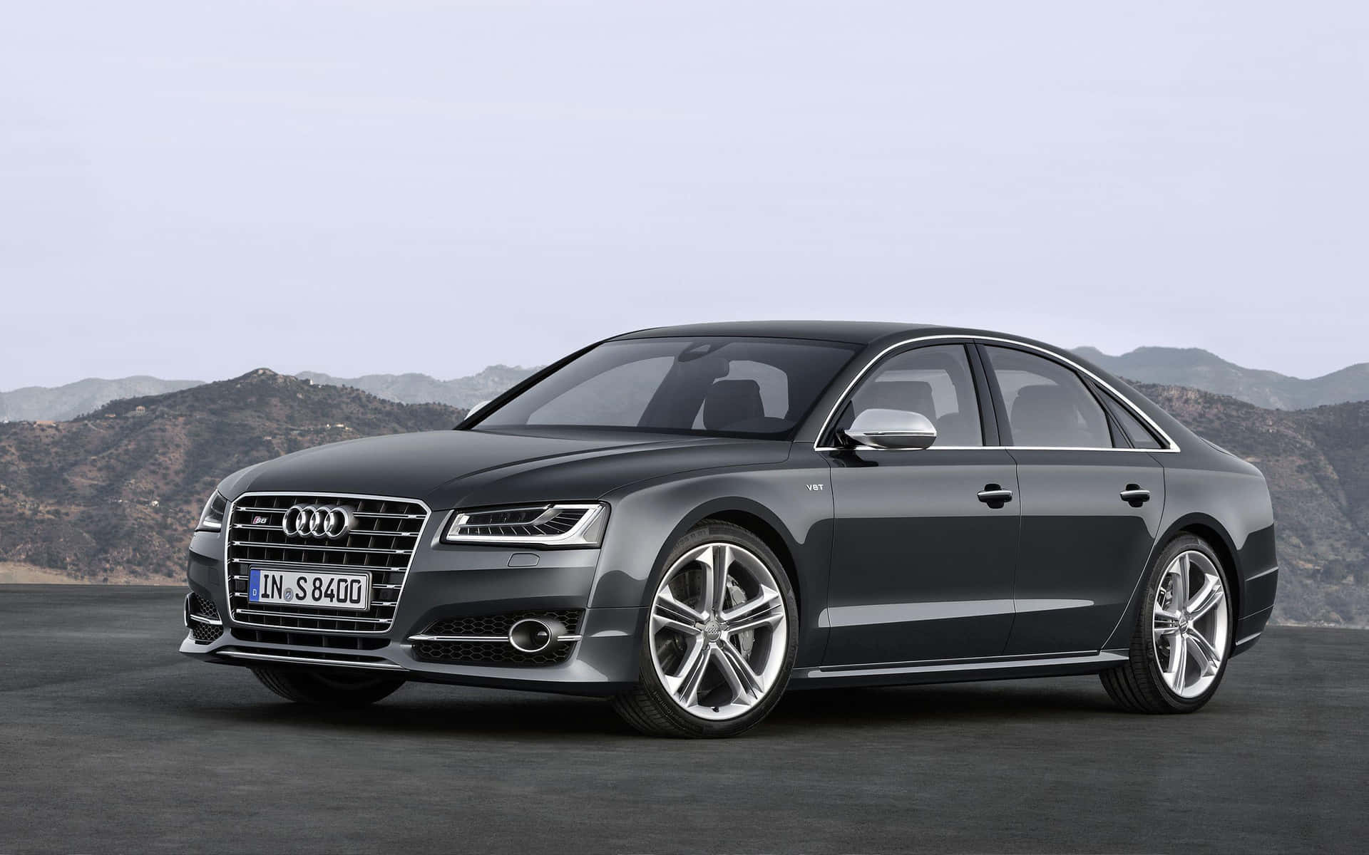 Striking Audi S8 luxury sports sedan in beautiful landscape Wallpaper