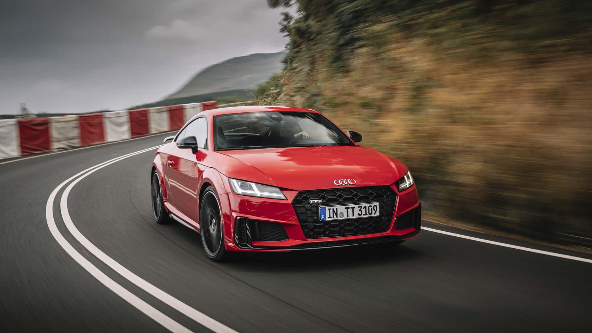 Sleek Red Audi TT Parked on Roadside Wallpaper