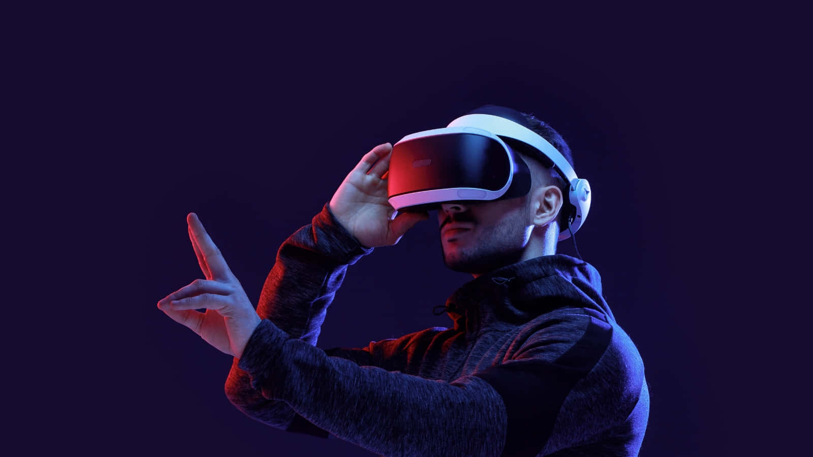 A Man Wearing A Virtual Reality Headset Wallpaper