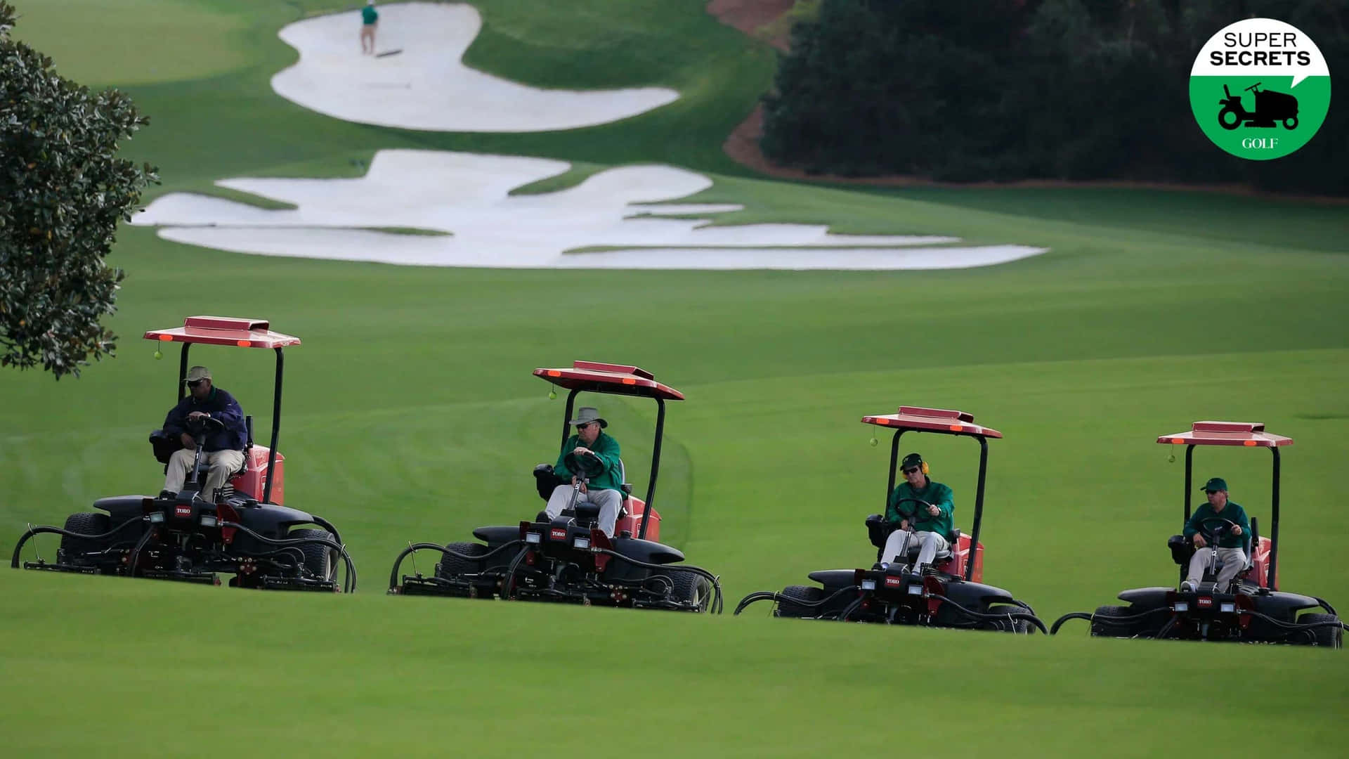 Four Golf Carts On A Green Grassy Field Wallpaper