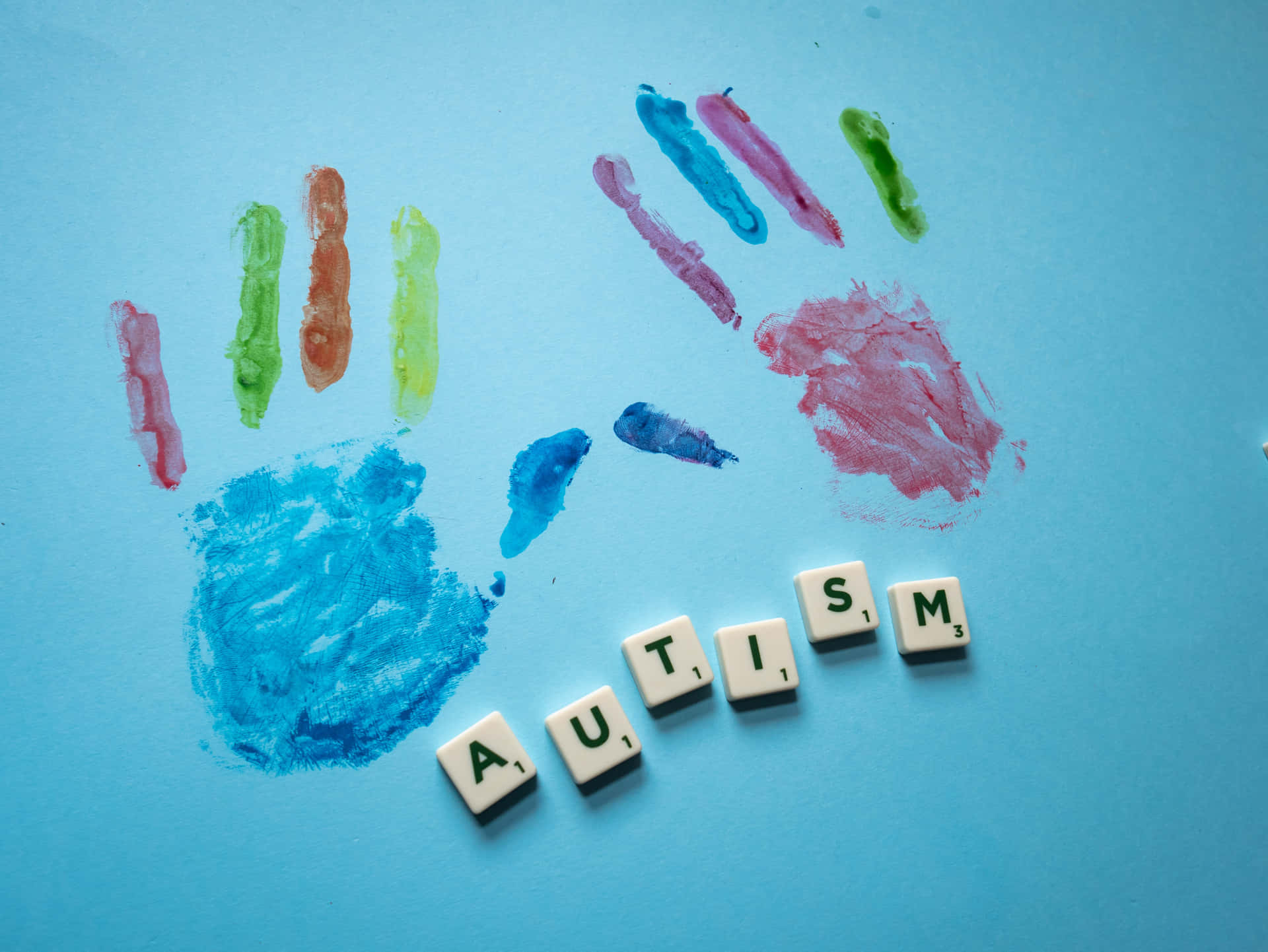 Improntedi Mani Legate All'autismo Su Sfondo Blu