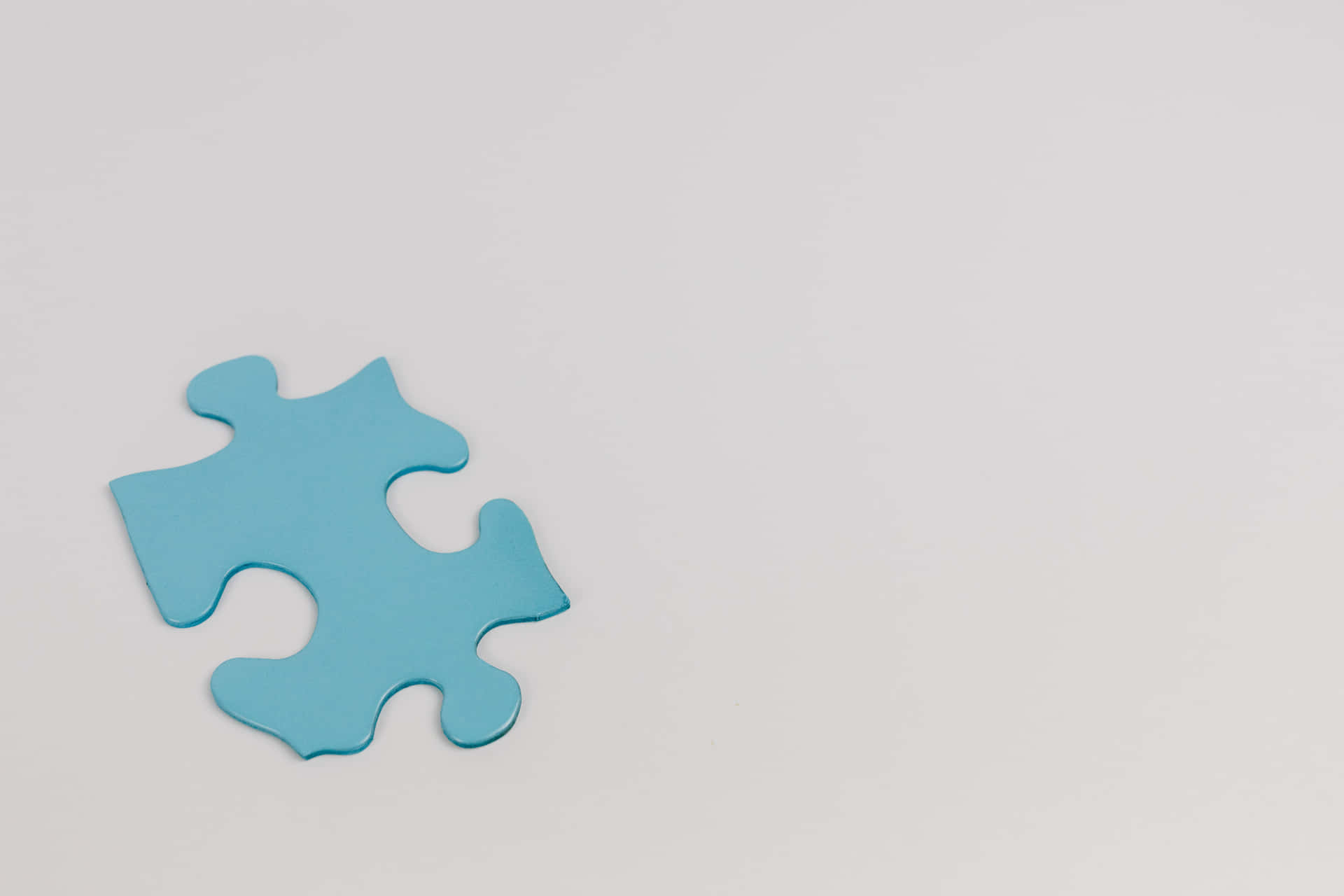 A Blue Puzzle Piece On A White Background