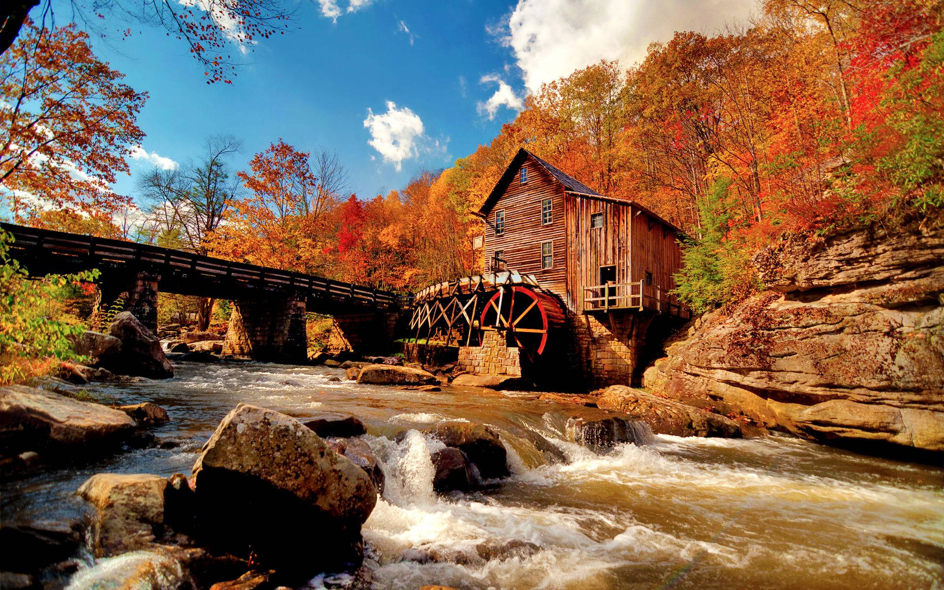 A Scenic Autumn Landscape with River and a Warm House Wallpaper
