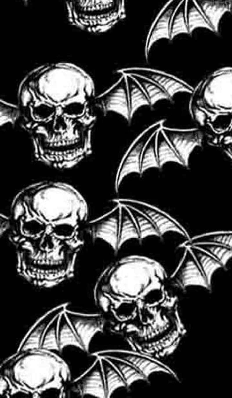 A Black And White Image Of Skulls And Bats Wallpaper