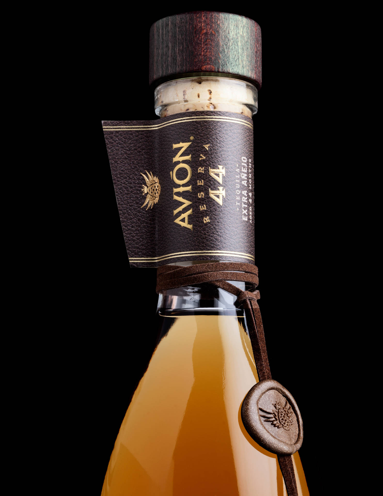 Luxurious crafted Avion Tequila resting on a rustic backdrop Wallpaper