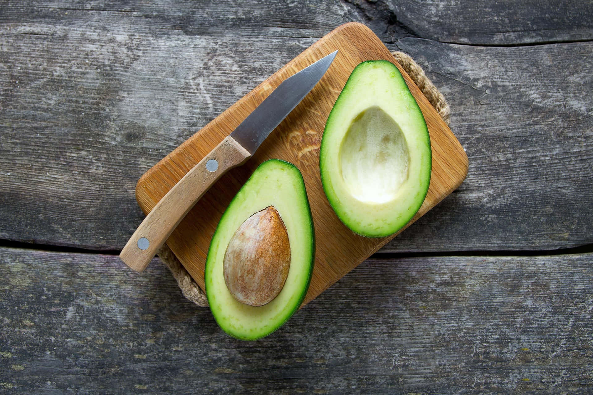 Chopped Avocados In A Bowl On Cutting Board On Wooden Background. Half  Avocado With Pulp And Seed, Whole Green Fresh Tropical Fruit On Brown  Table, Top View Stock Photo, Picture and Royalty