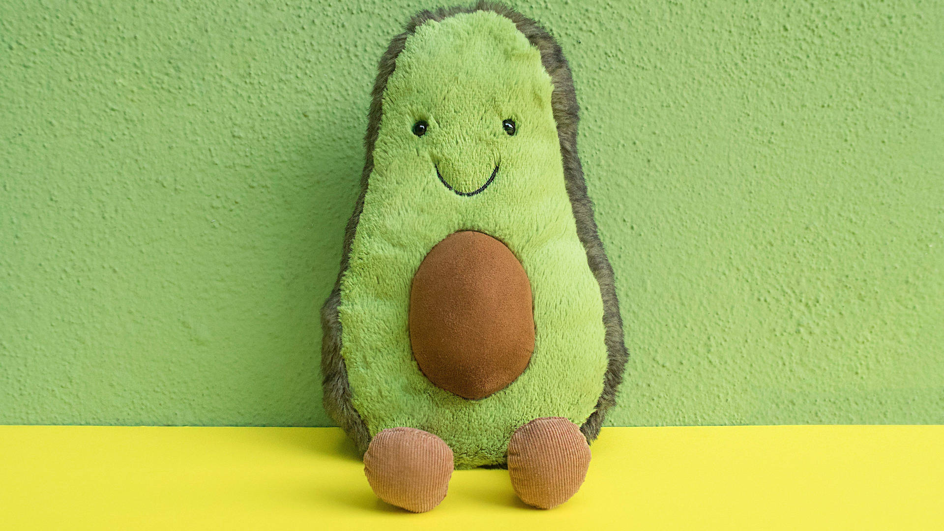 Avocado Stuffed Toy On Pastel Green Wallpaper