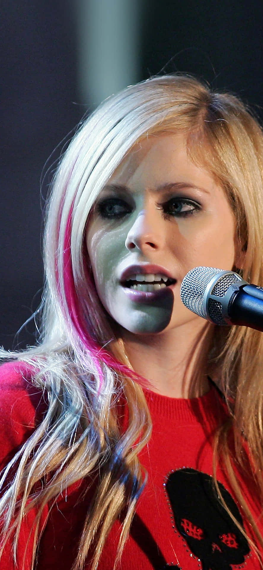 Avril Lavigne performing on stage