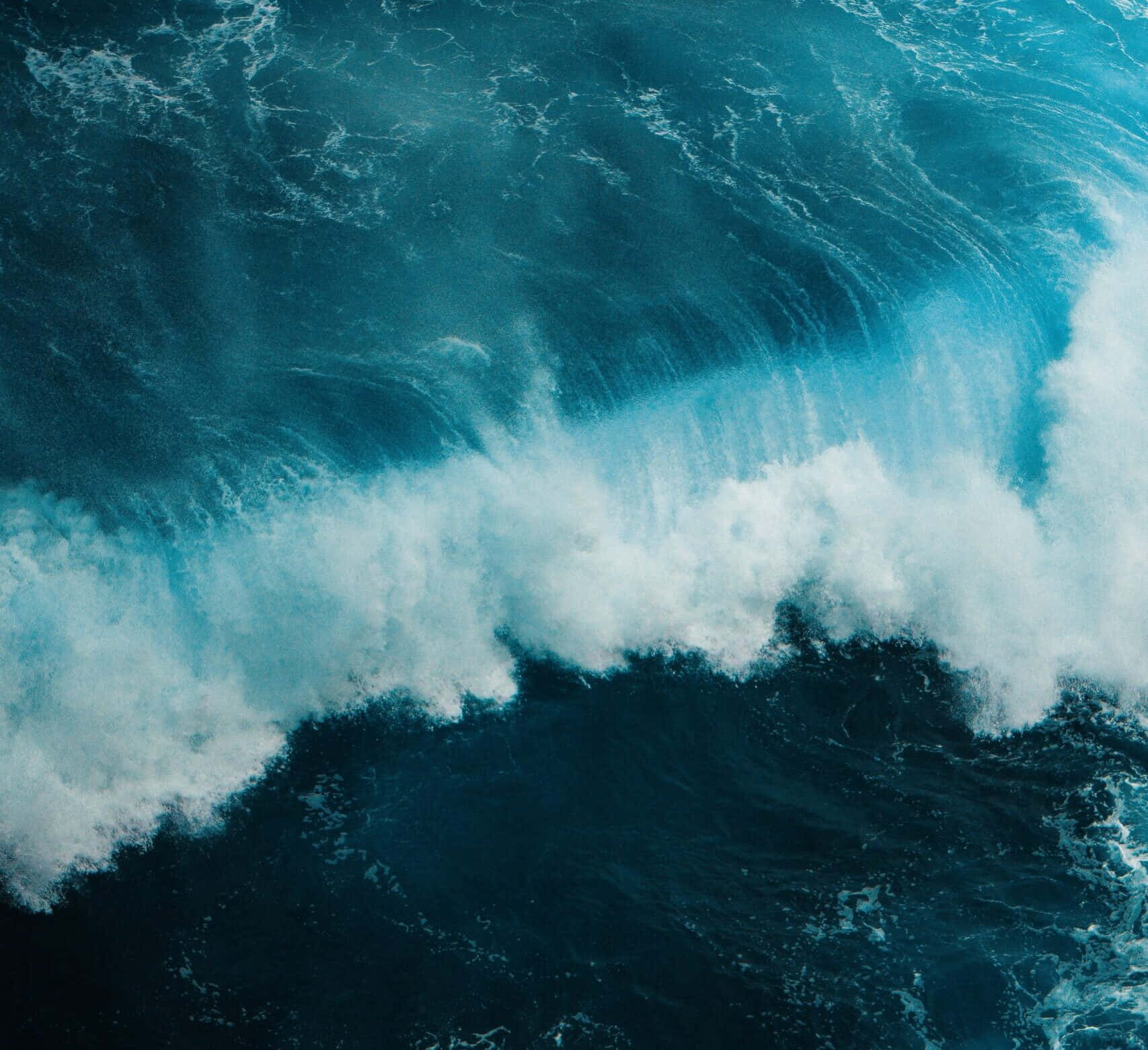 Awe-inspiring Power Of Nature: Tsunami In Motion Wallpaper