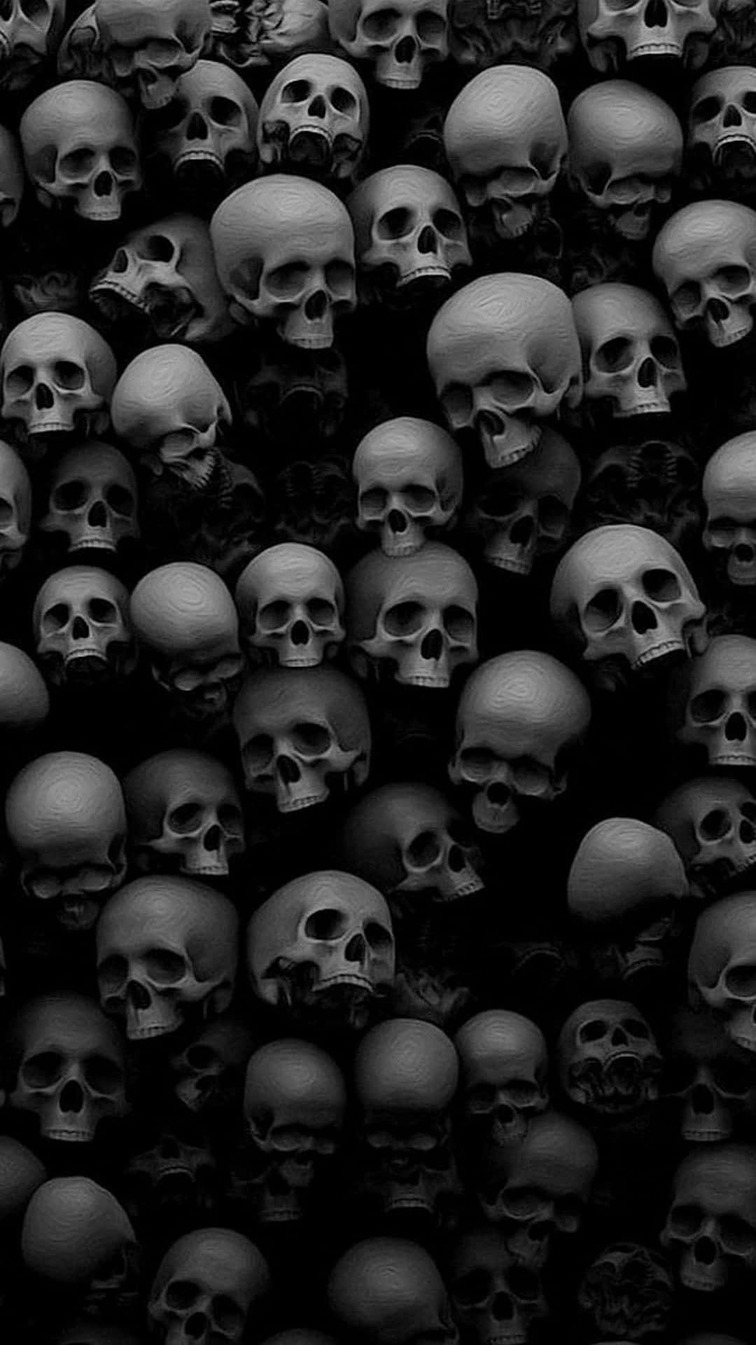 A Black And White Photo Of Many Skulls Wallpaper