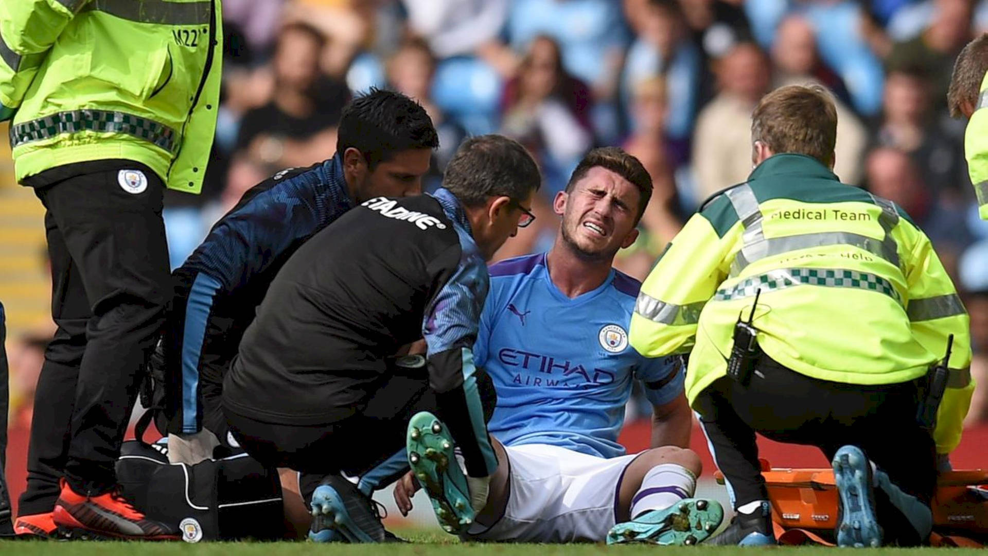 Aymeric Laporte Surrounded By Medics Wallpaper