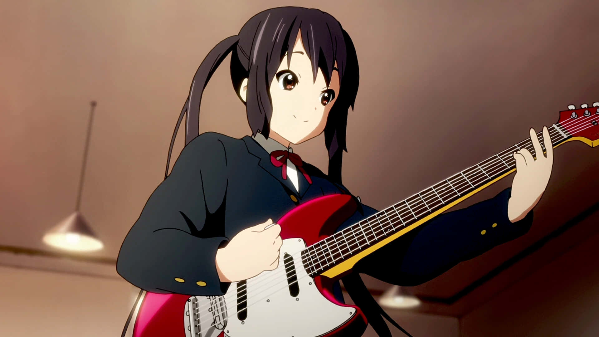 Azusa Nakano Striking A Pose With Her Guitar Wallpaper