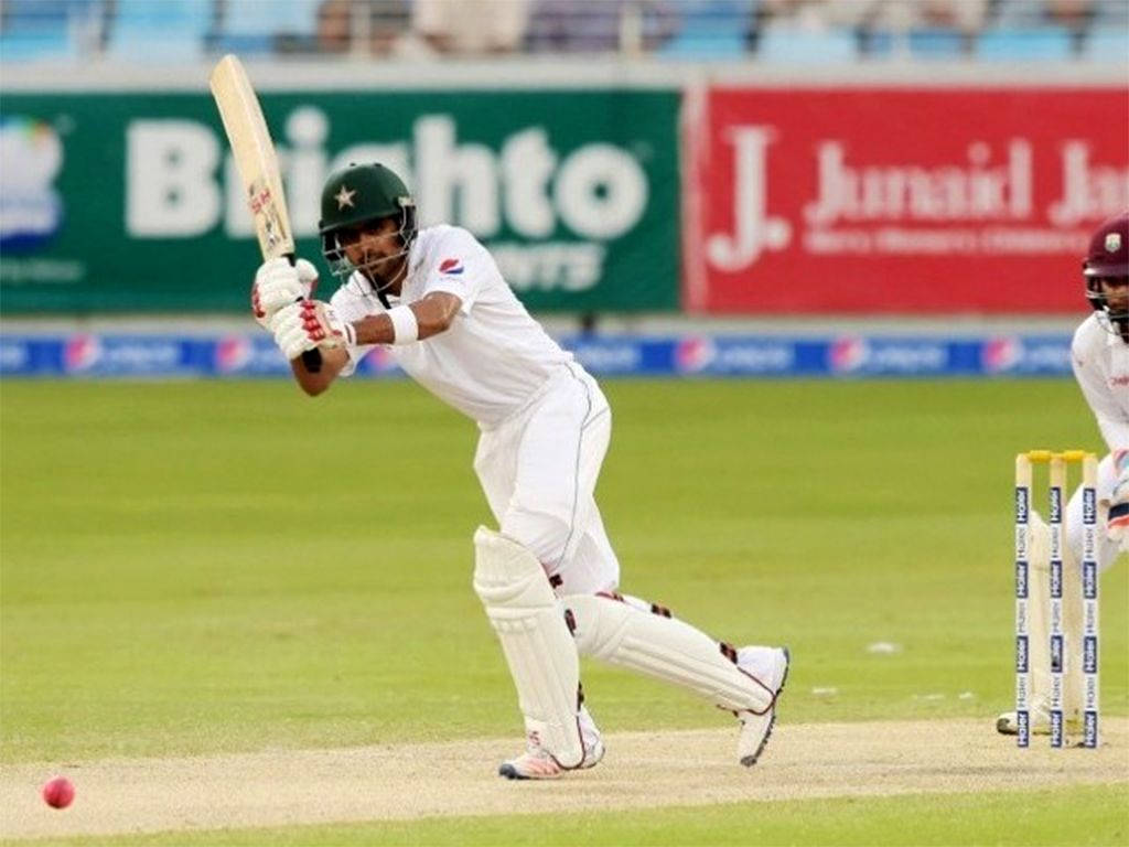 Babar Azam In White Cricket Uniform Wallpaper