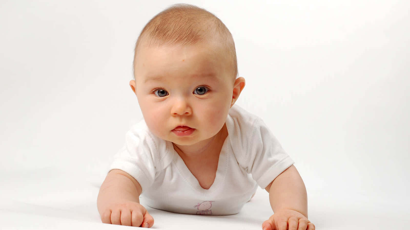 A Baby Is Laying On A White Background