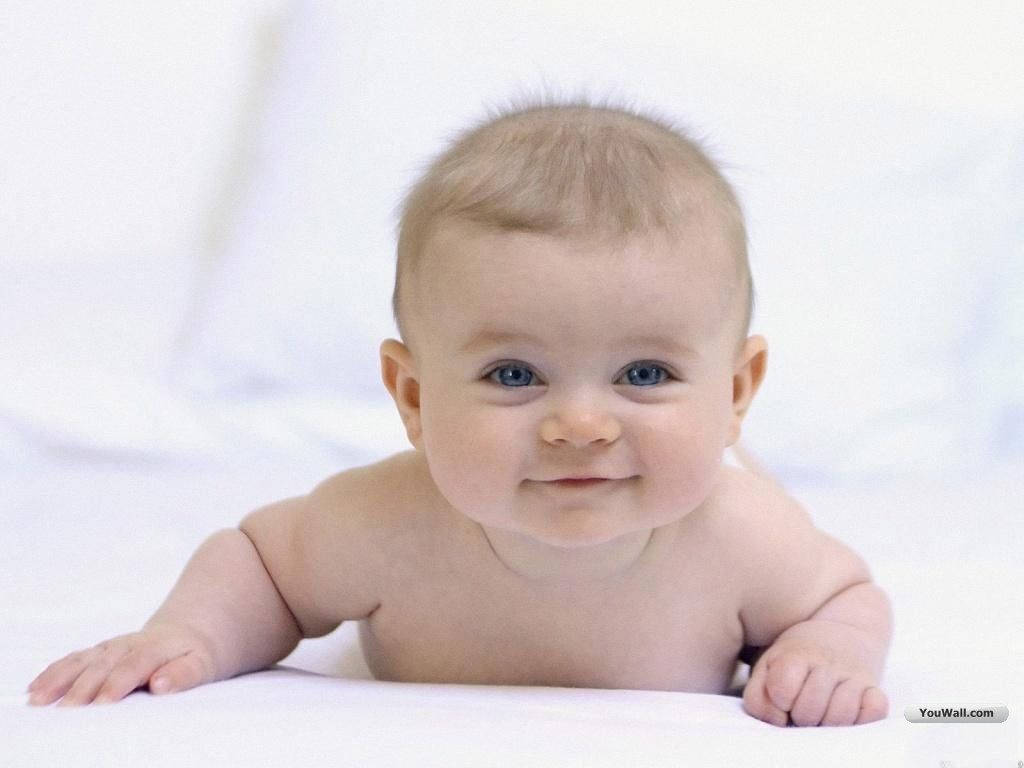 Download A sweet little baby boy in white Wallpaper | Wallpapers.com