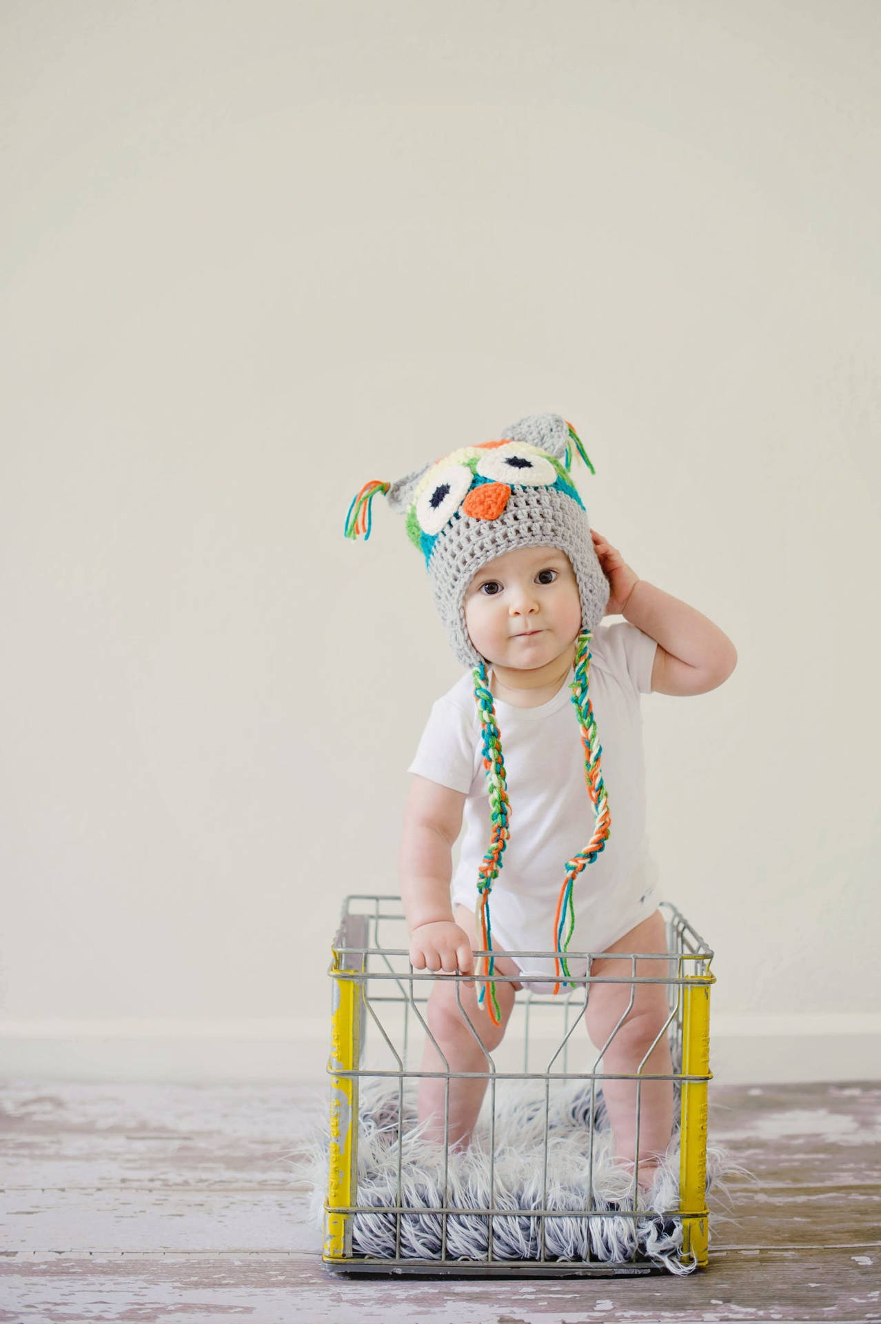 Baby Boy Standing Inside A Basket Wallpaper