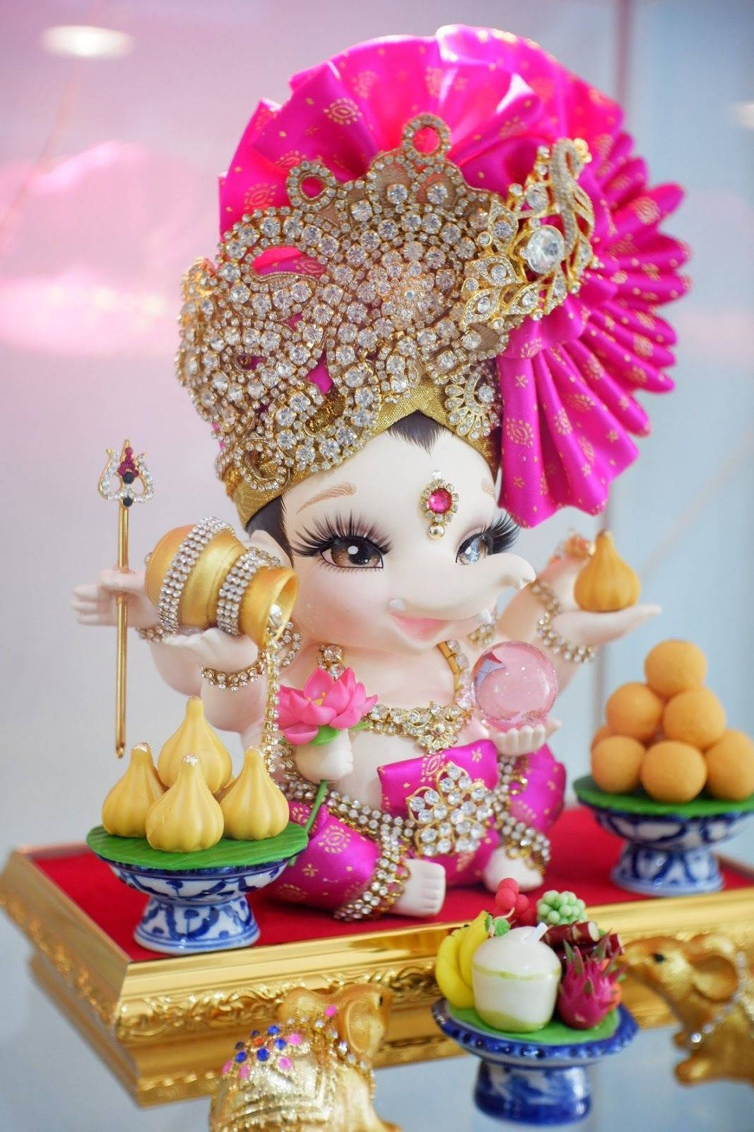Baby Ganesh Food Offerings Wallpaper