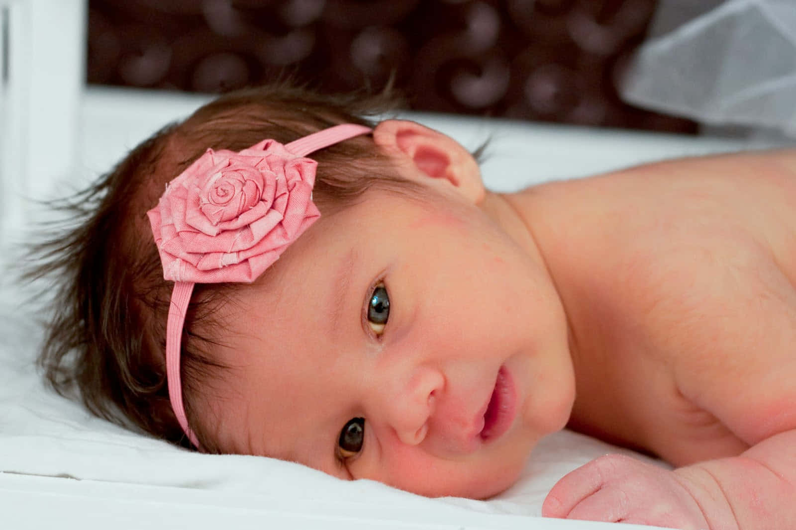 newborn baby girl with green eyes and brown hair