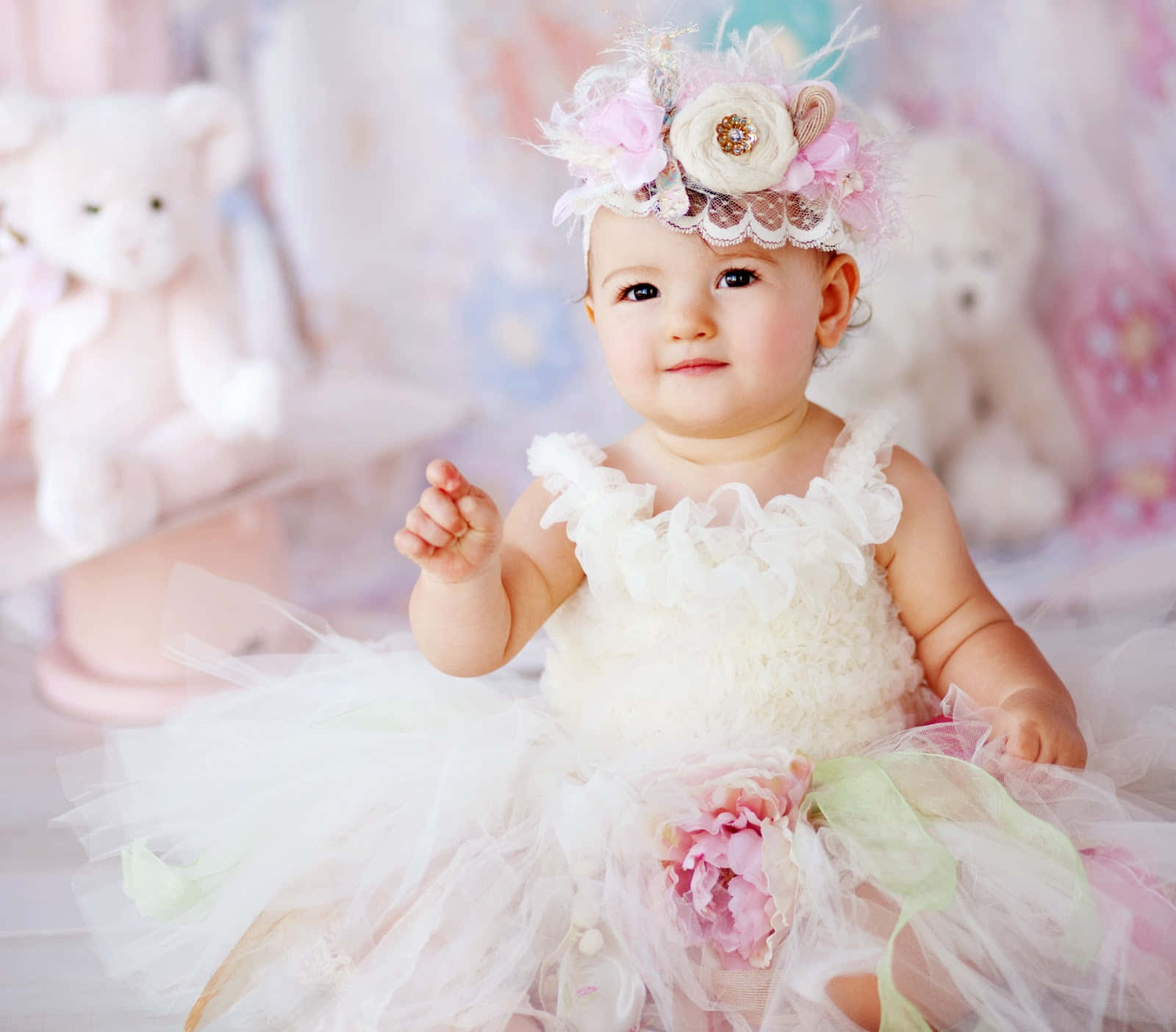 A Baby Girl In A Tutu Sitting On A White Floor