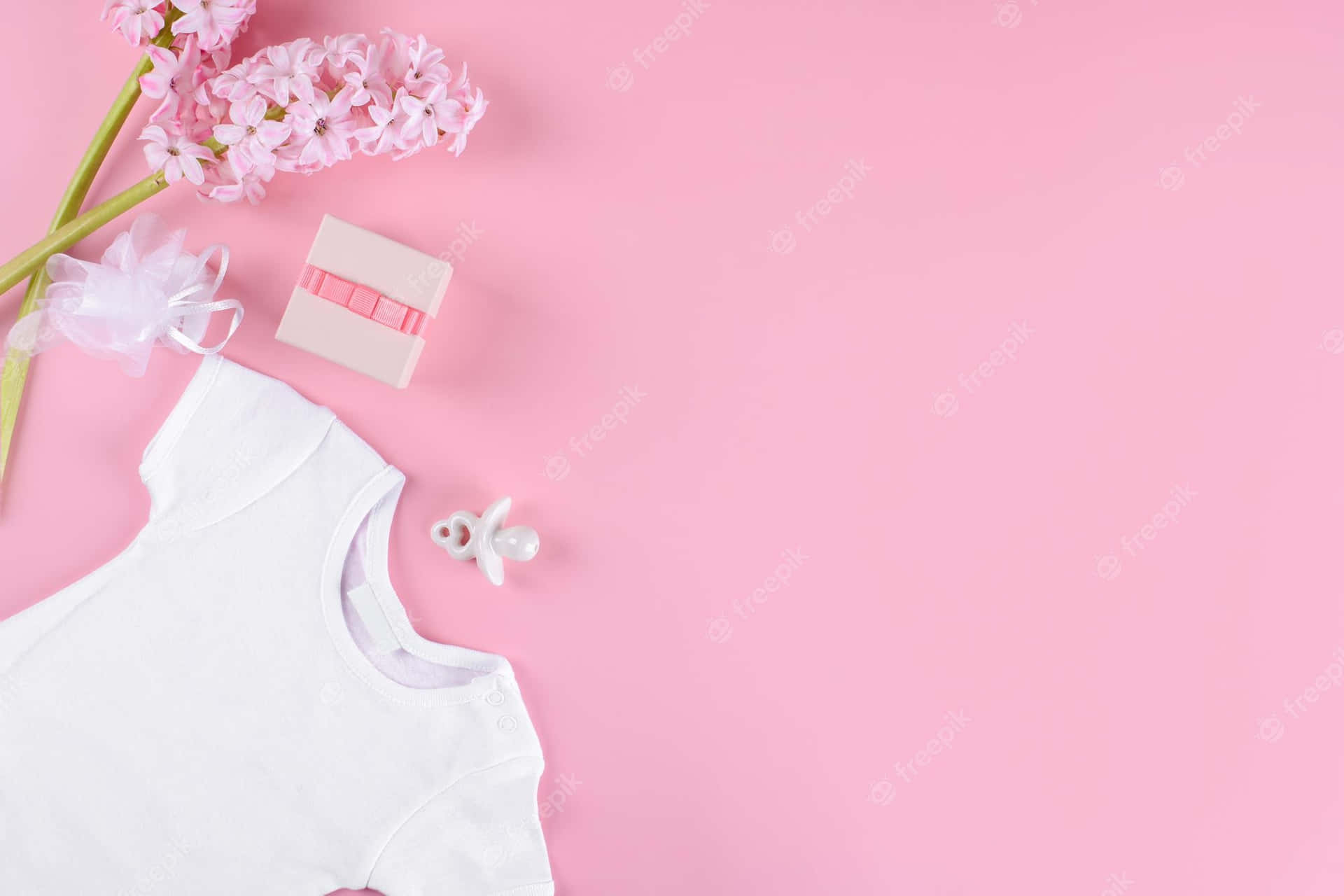A White Baby Bodysuit On Pink Background With Flowers Wallpaper