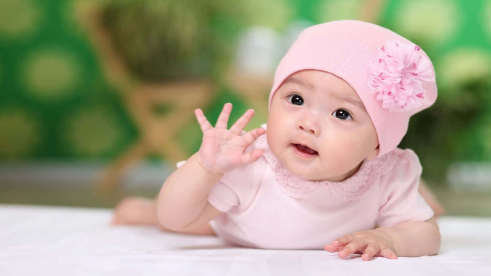 Image  "Adorable baby girl dressed in pink looking her best" Wallpaper