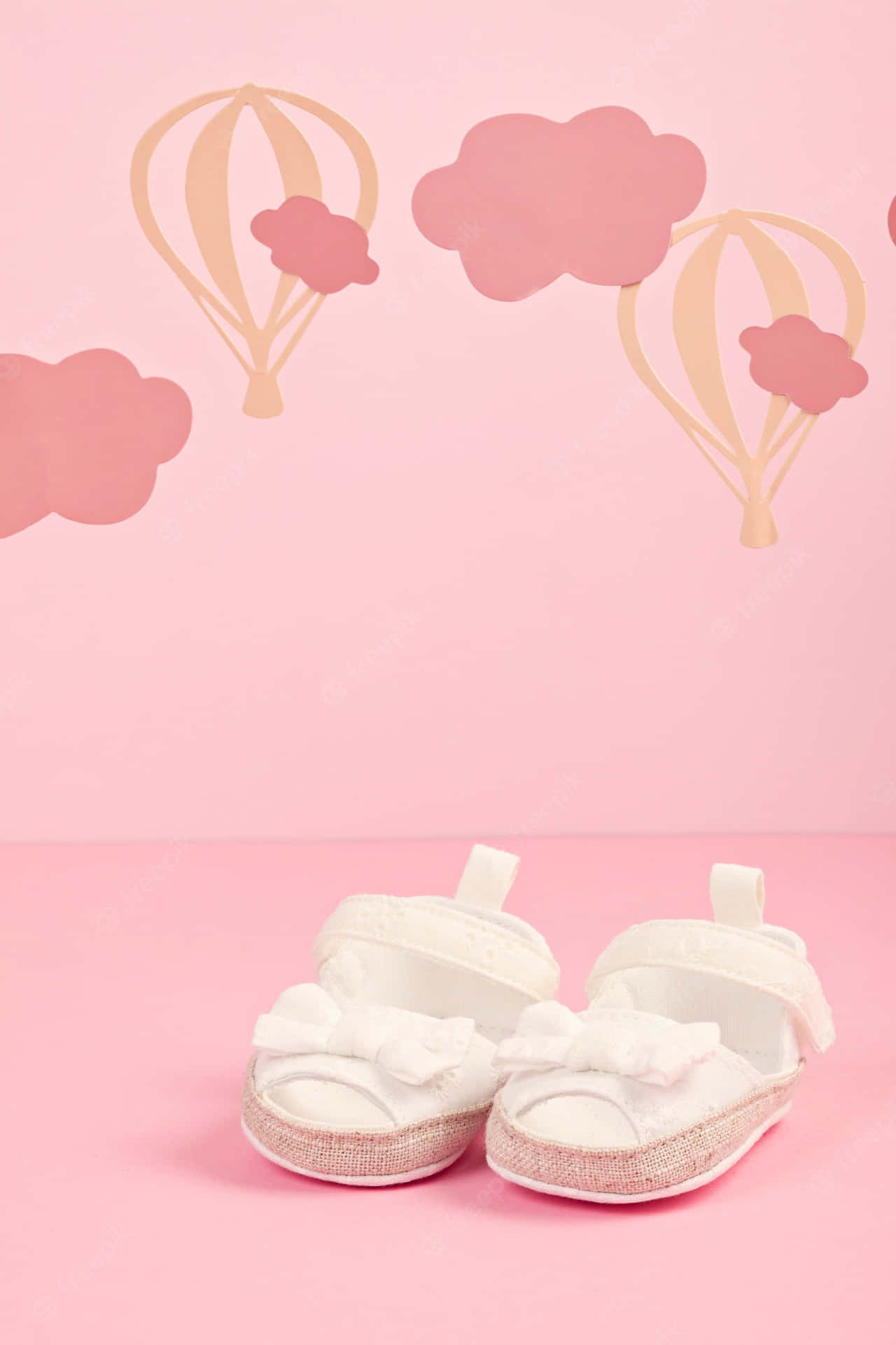 Baby Shoes With Hot Air Balloons On A Pink Background Wallpaper