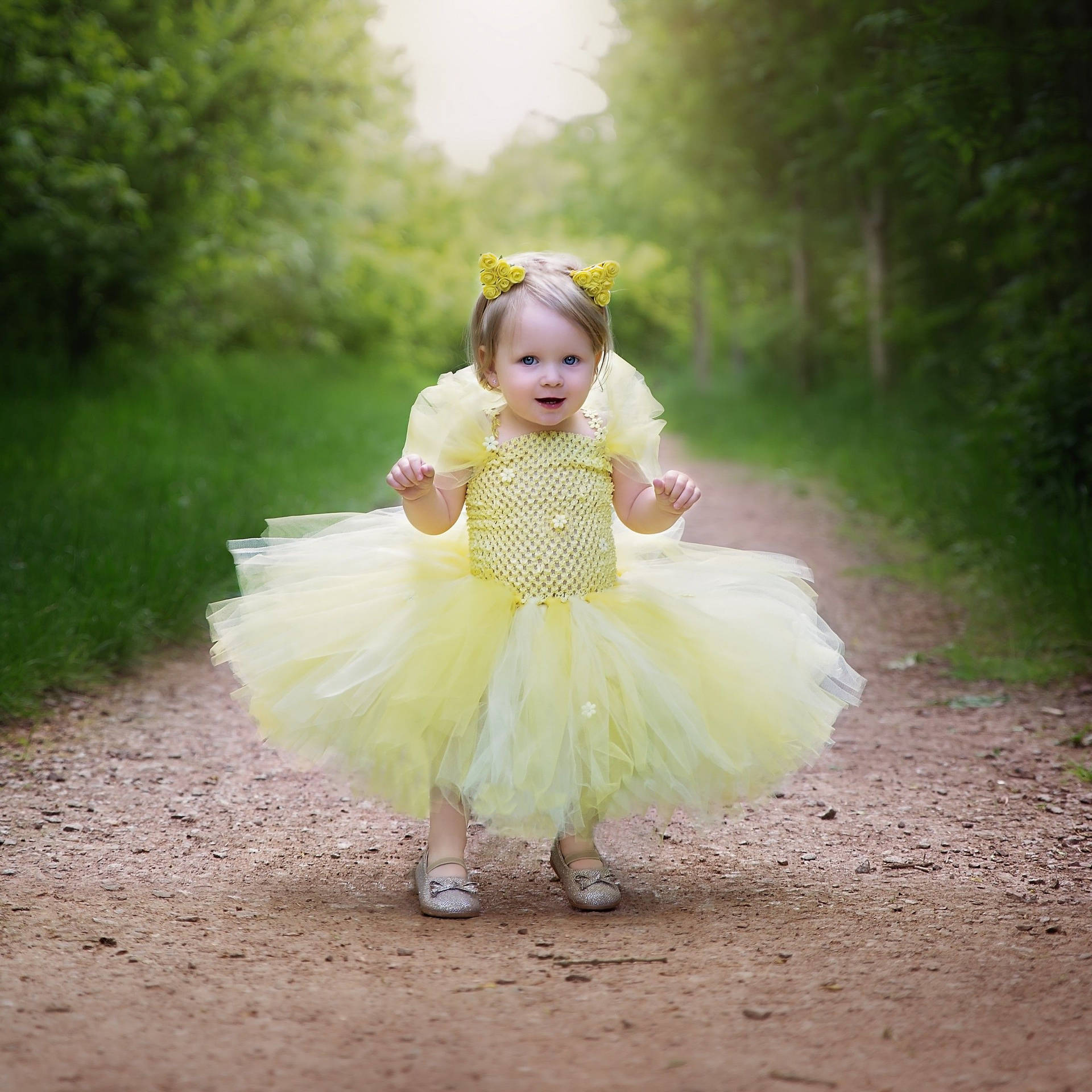 Delightful Baby Girl in Yellow Gown Wallpaper