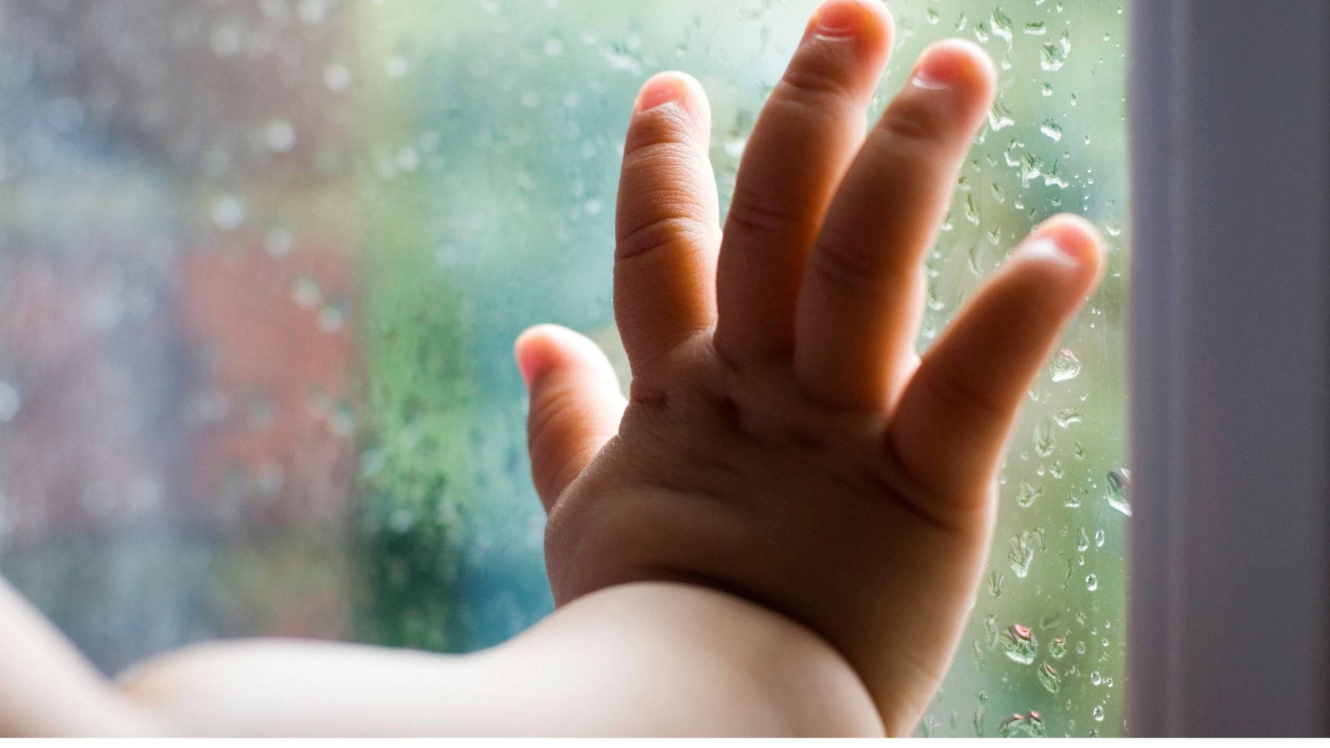 Baby Hand Leaning On Glass Panel Wallpaper