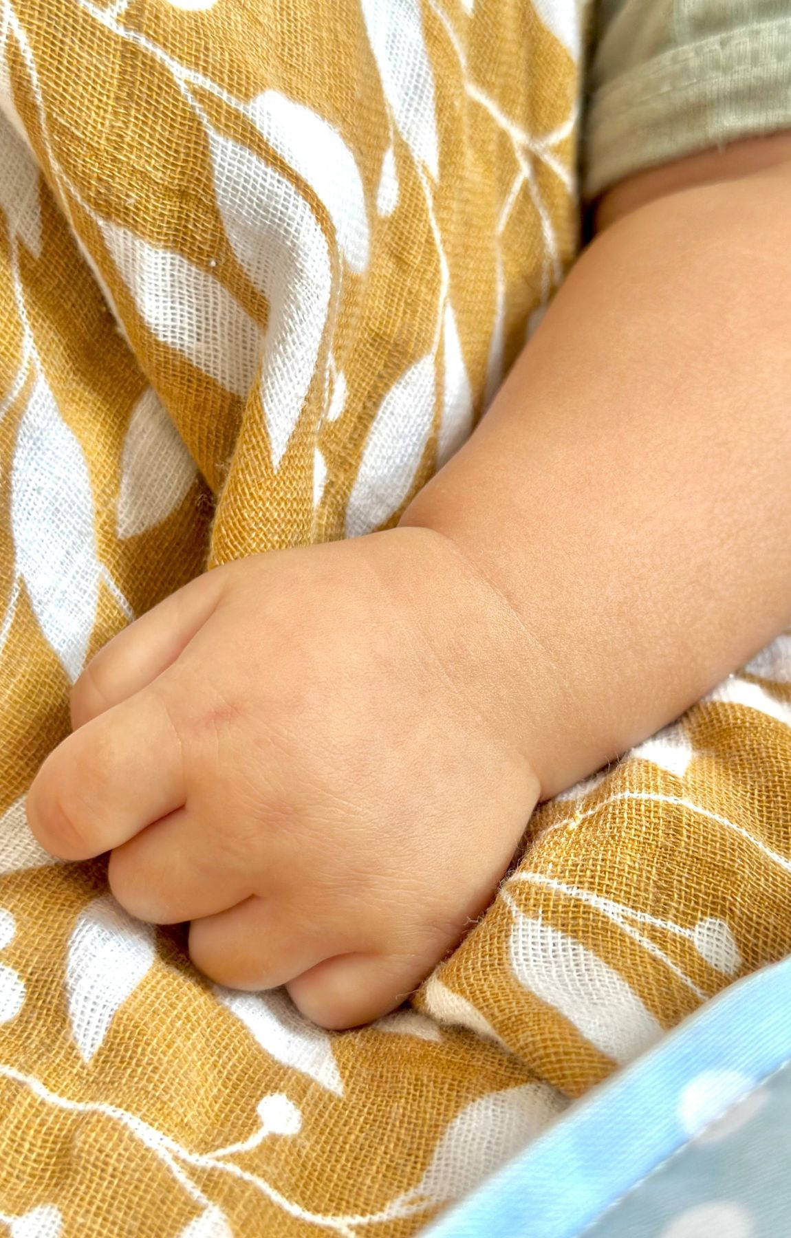 Baby Hand On A Brown Cloth Wallpaper