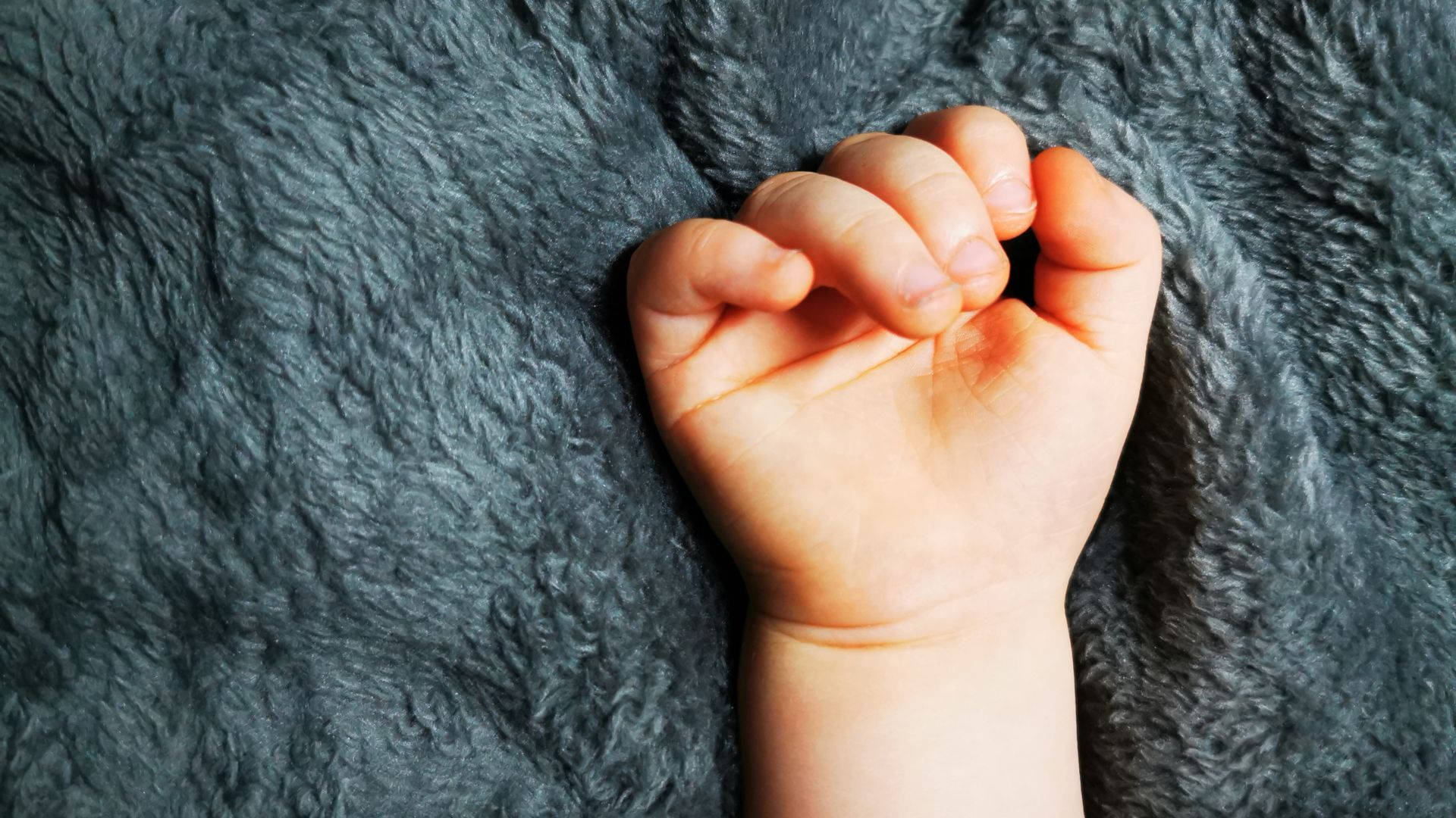 Baby Hand On A Cozy Blanket Wallpaper