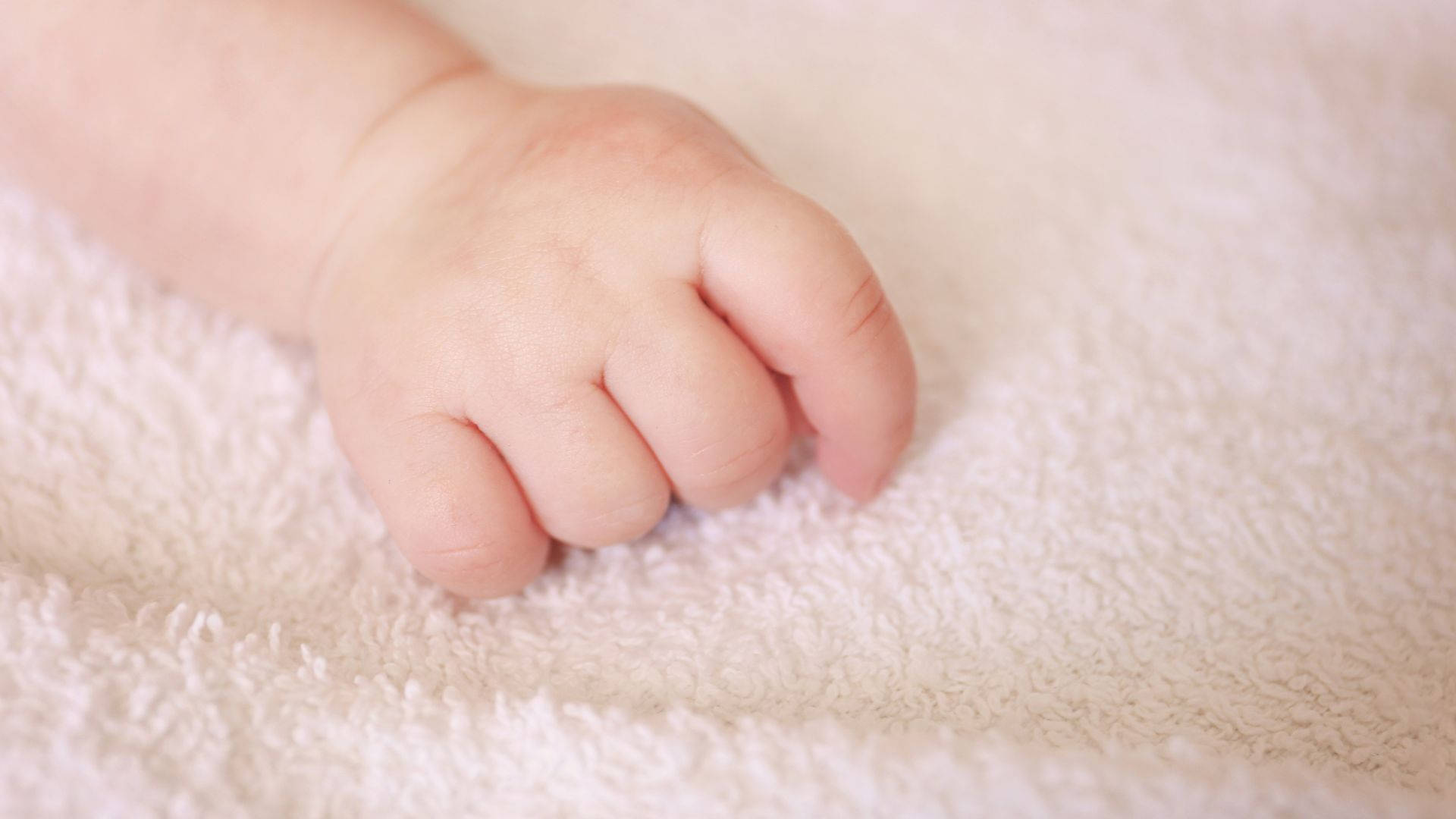 Baby Hand On A Soft Towel Wallpaper
