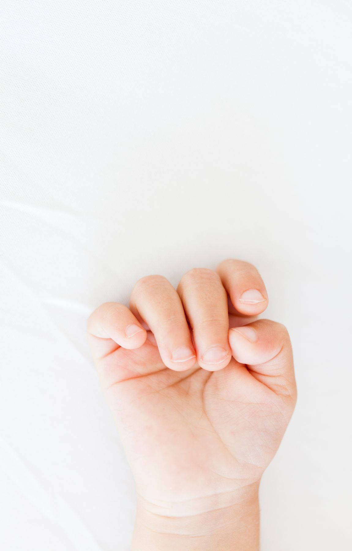 Touch of Innocence - Tiny Baby Hand Wallpaper