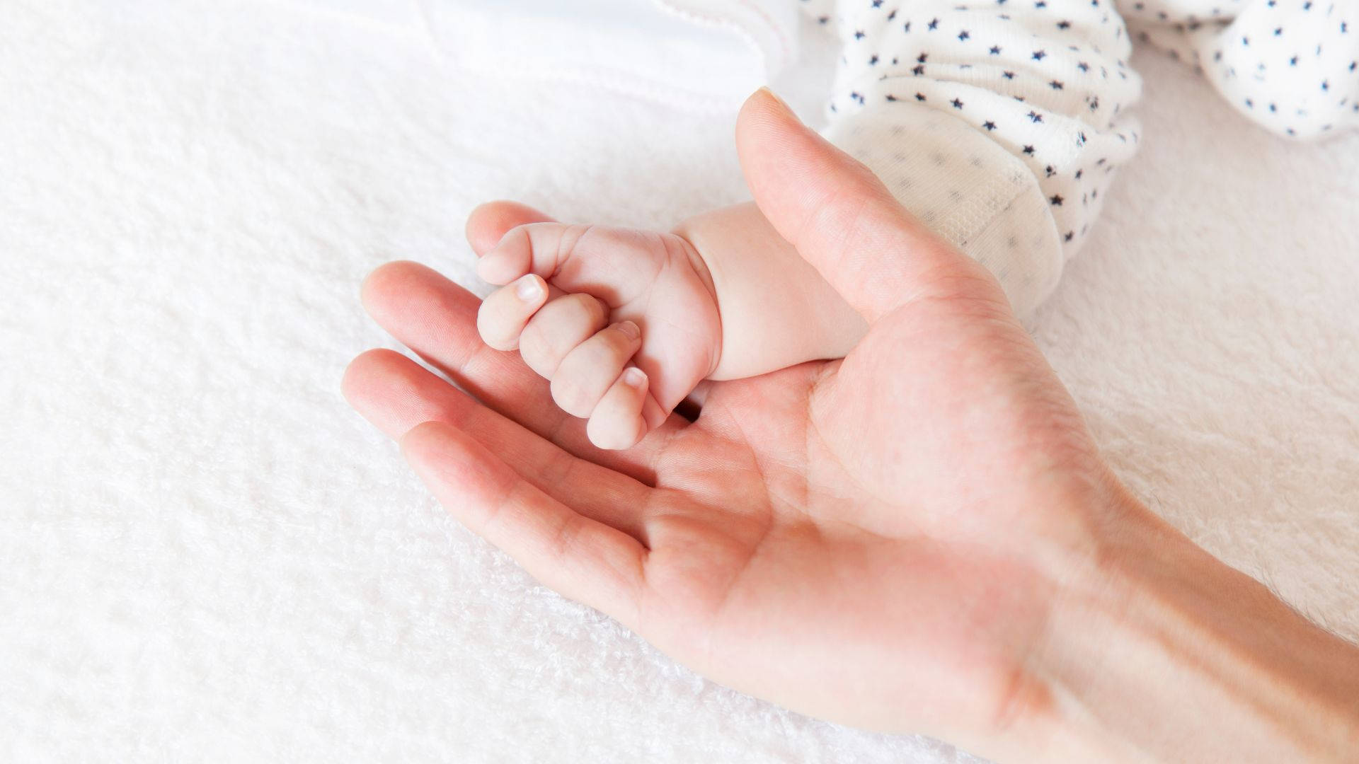 Baby Hand On An Open Hand Wallpaper